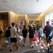 Students walk in a school hallway. 