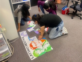 A Boltz Middle School student works on a banner for Hispanic Heritage Month. 
