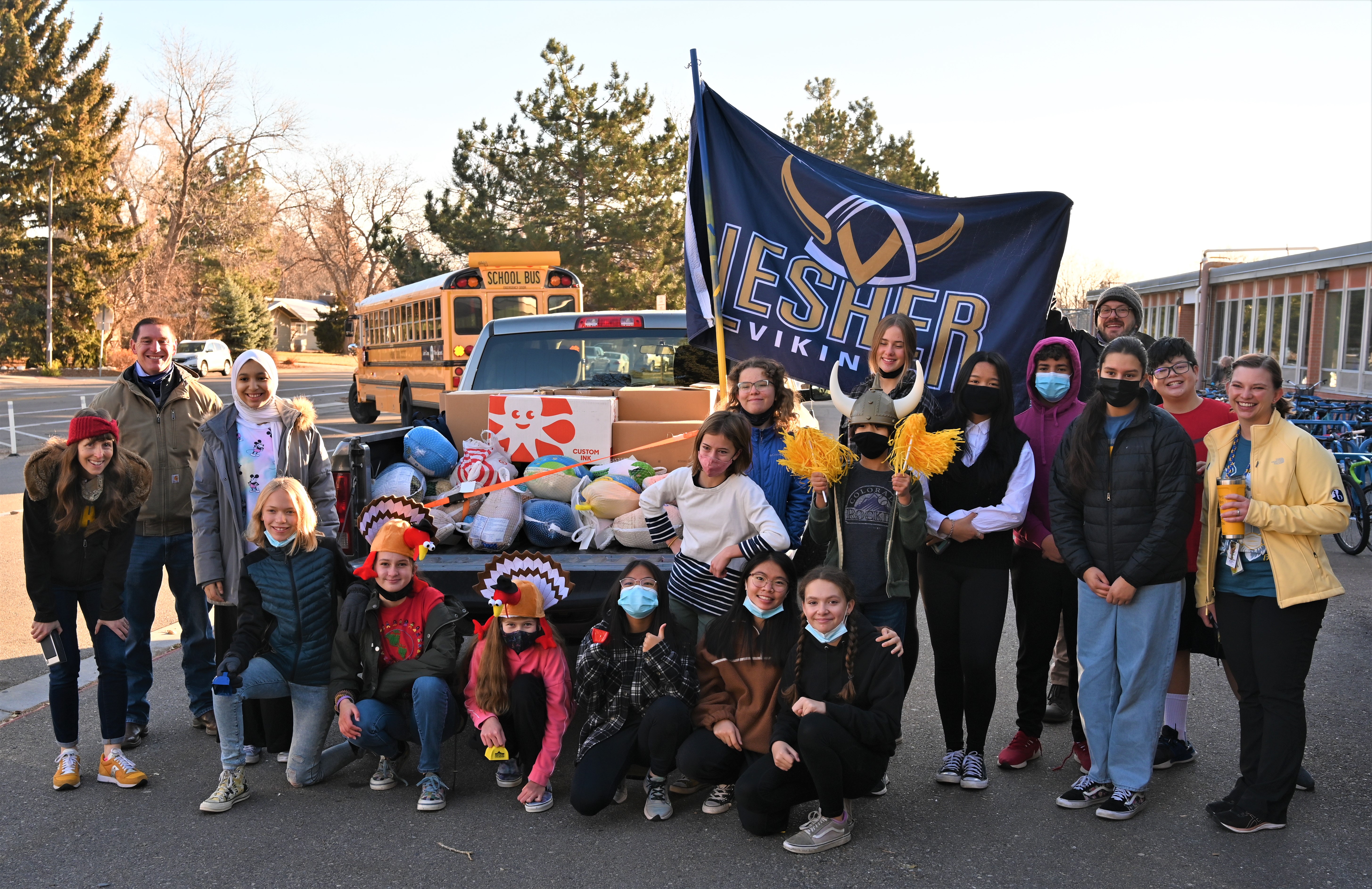 Lesher Middle School students and staff in front of the truck filled with turkeys.
