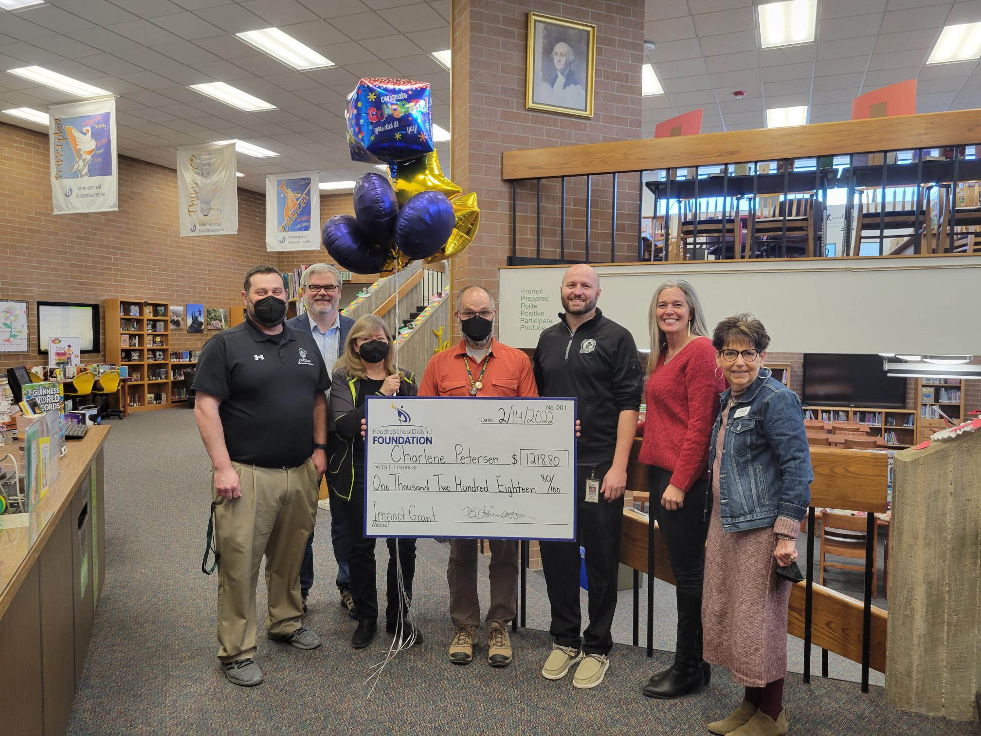 Staff accepting a large check for Impact Grant.