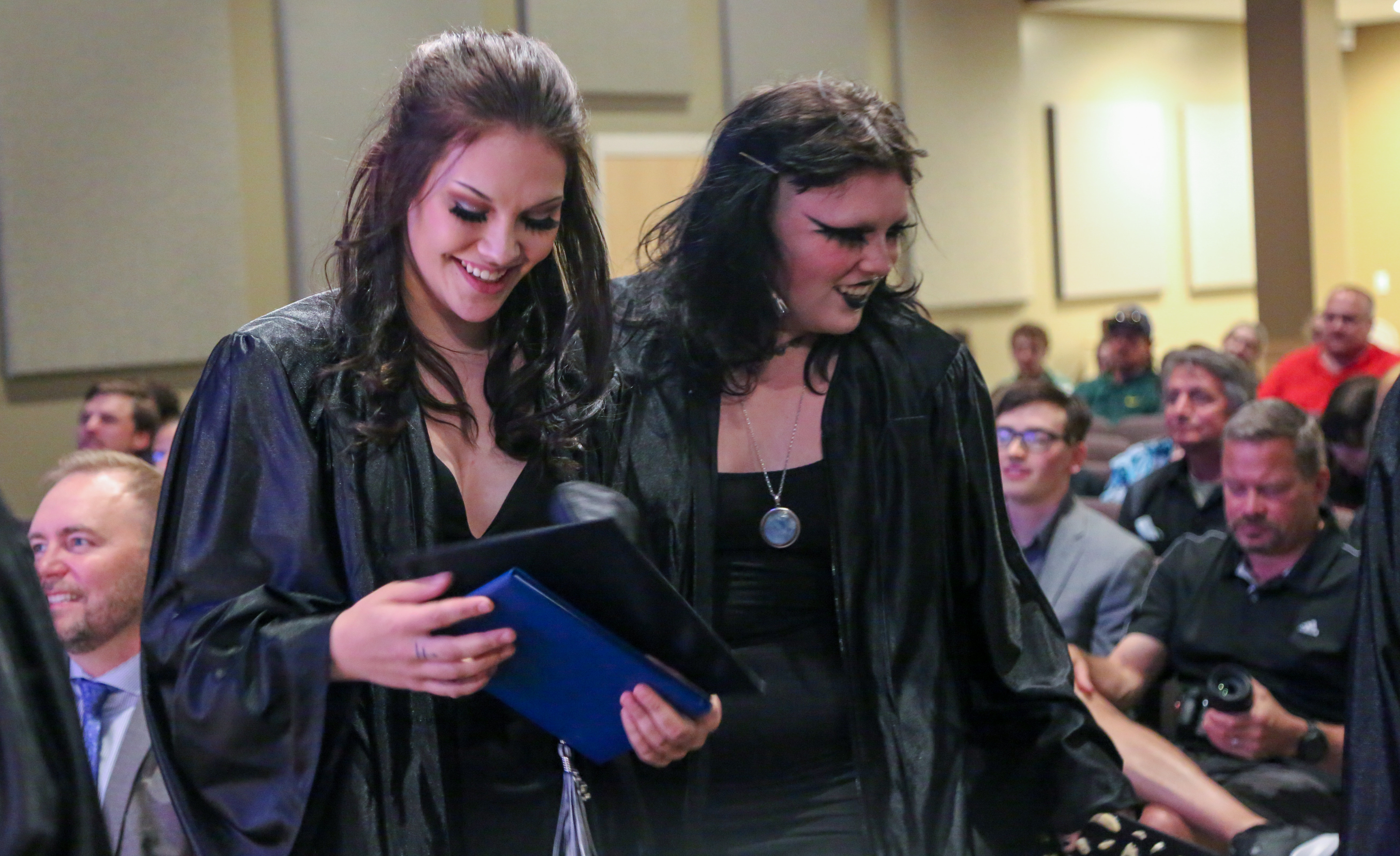 Two graduates walking together.