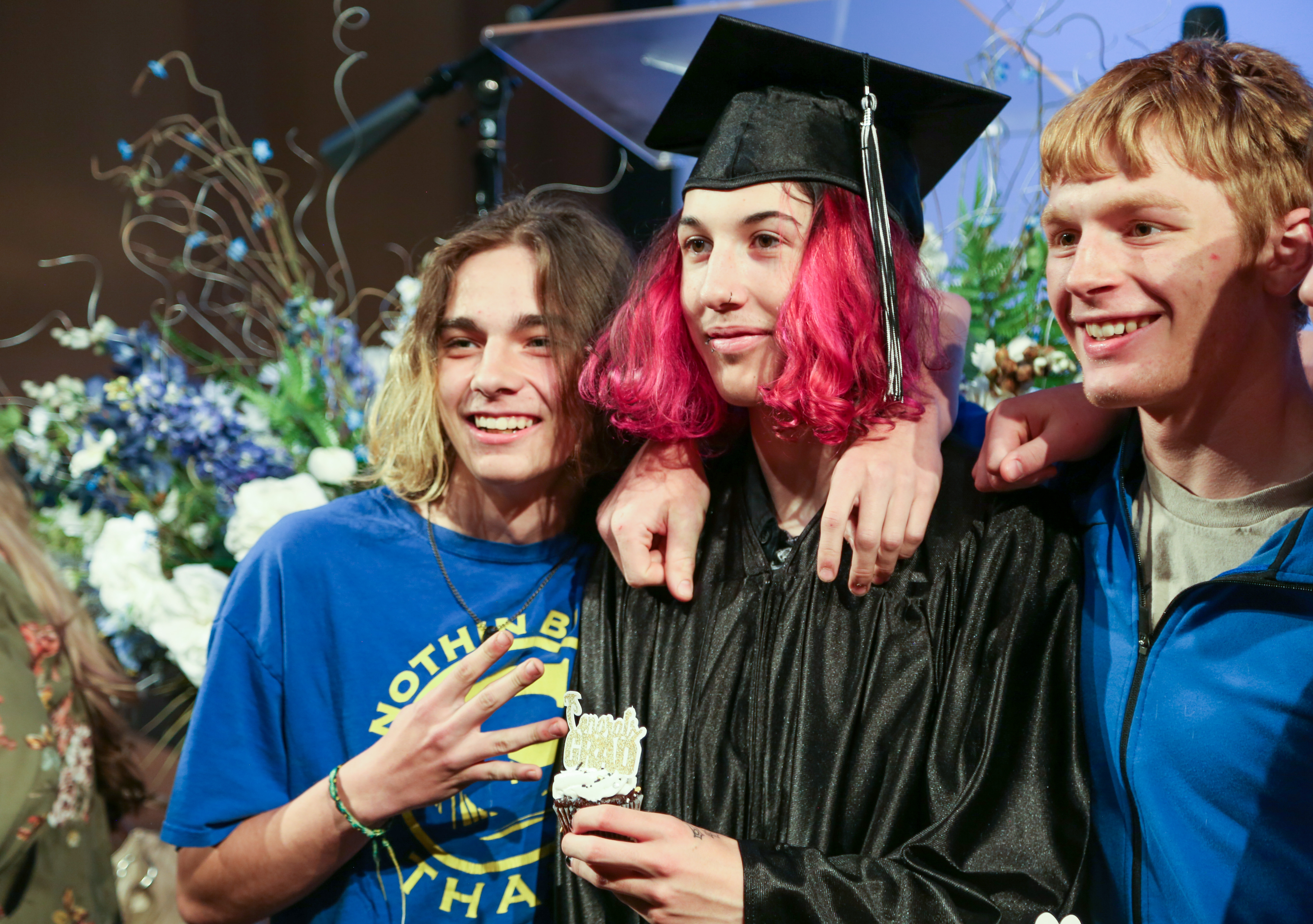 An Opportunities Unlimited graduate celebrates with supporters. 