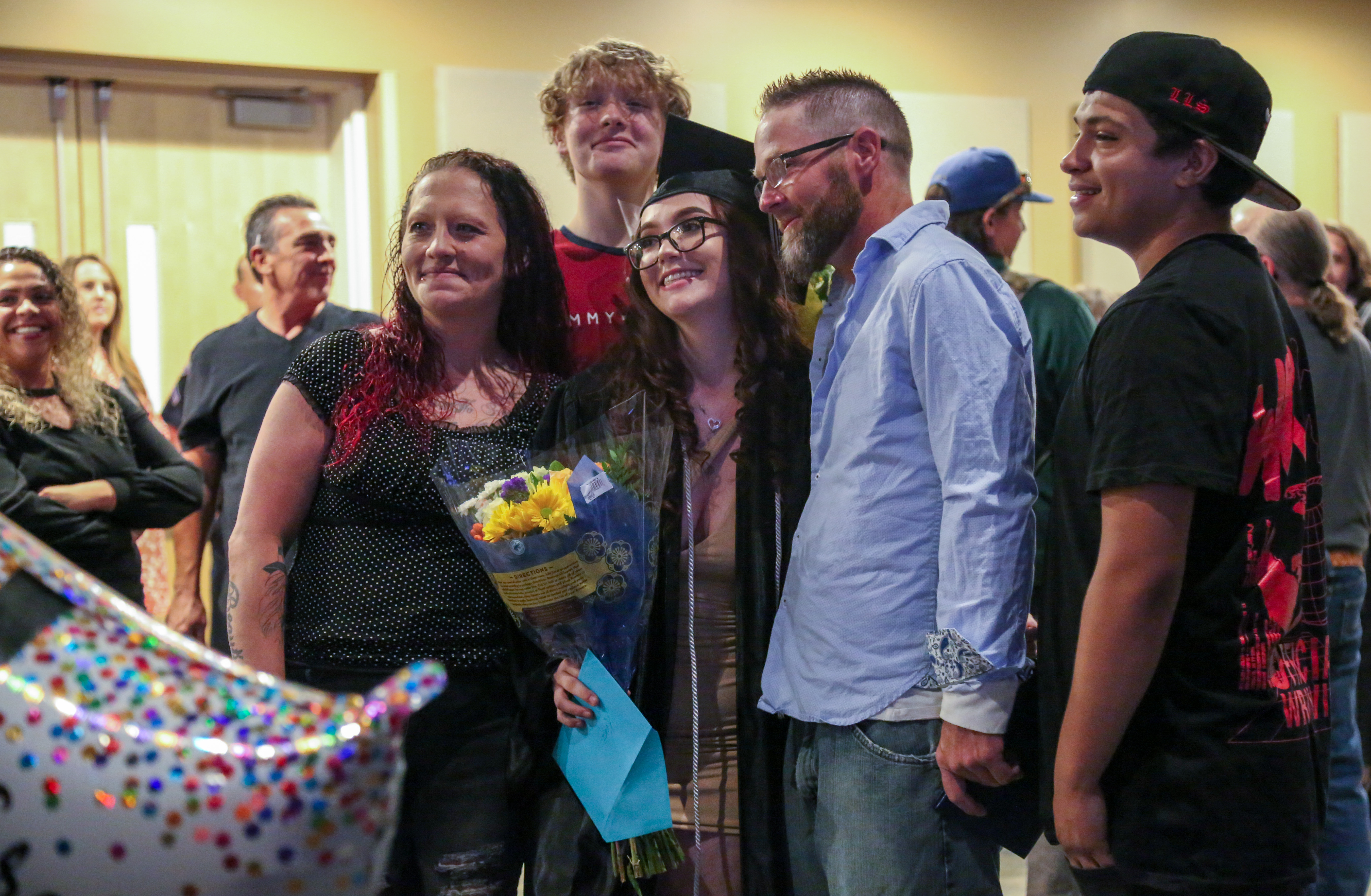 A PHS OU graduate poses with friends and family.