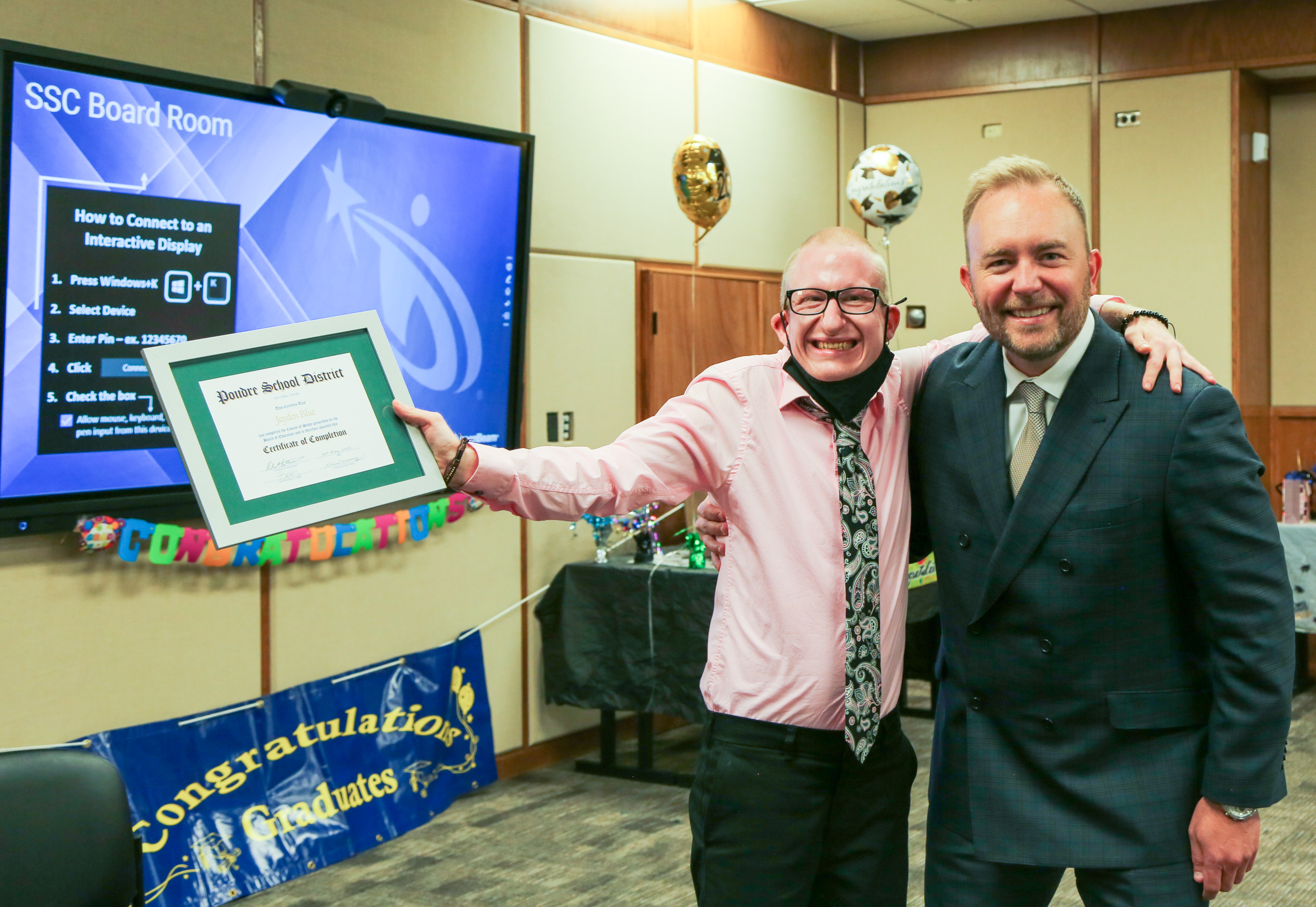 The PSD superintendent with a Community Connections graduate. 