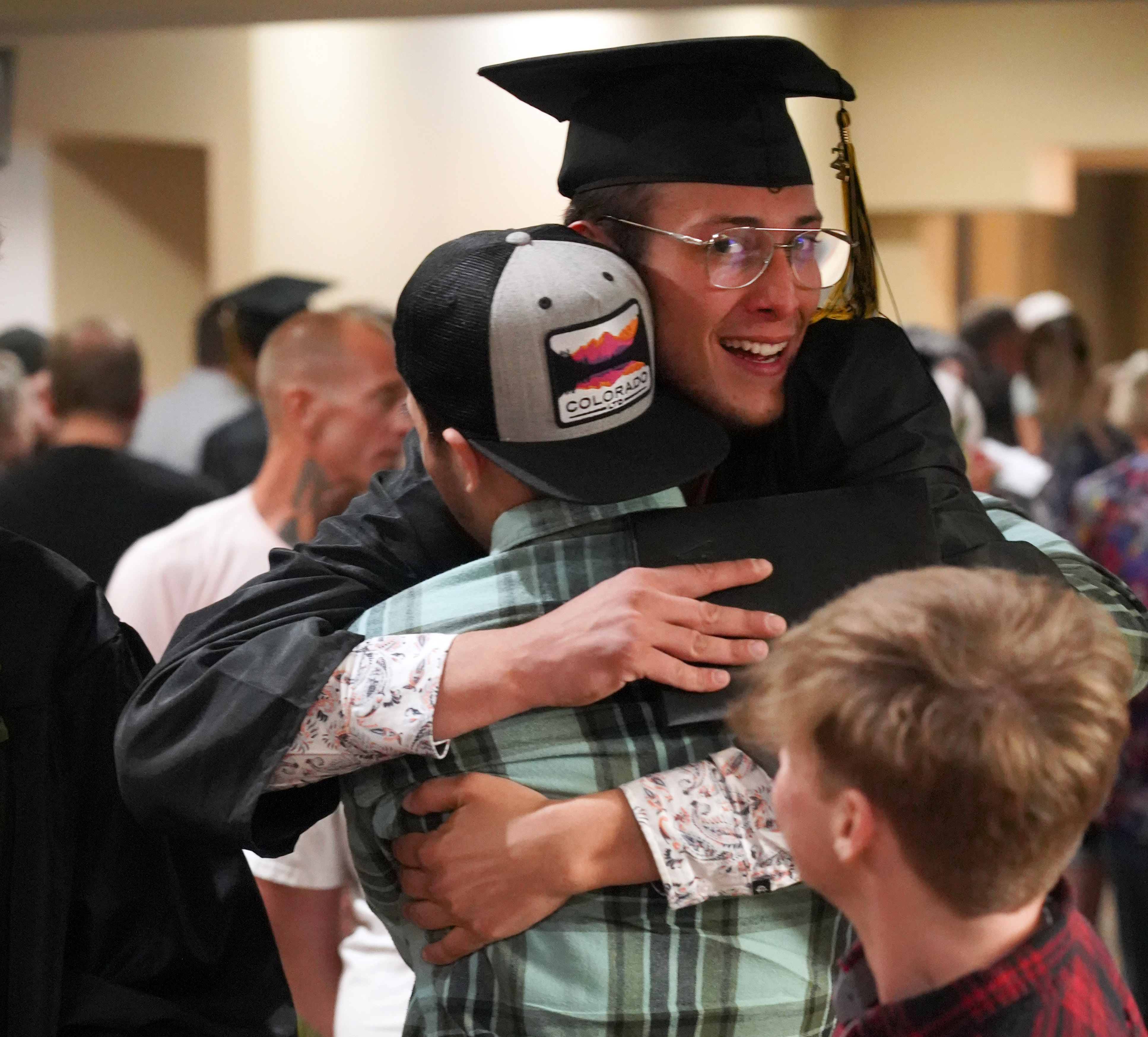 A Centennial High School grad gets a hug.