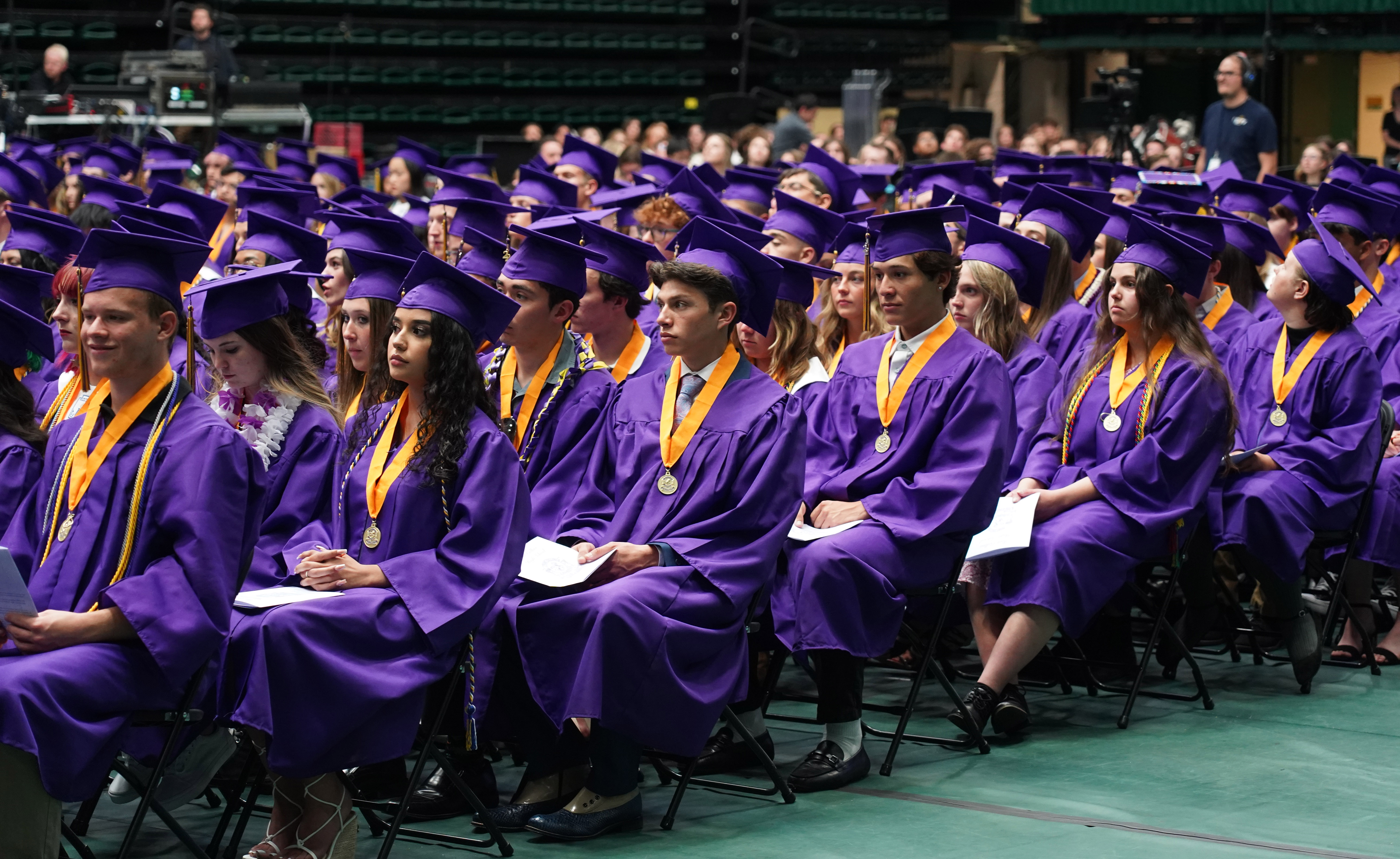 Fort Collins High School graduates sitting in rows at Moby Arena.