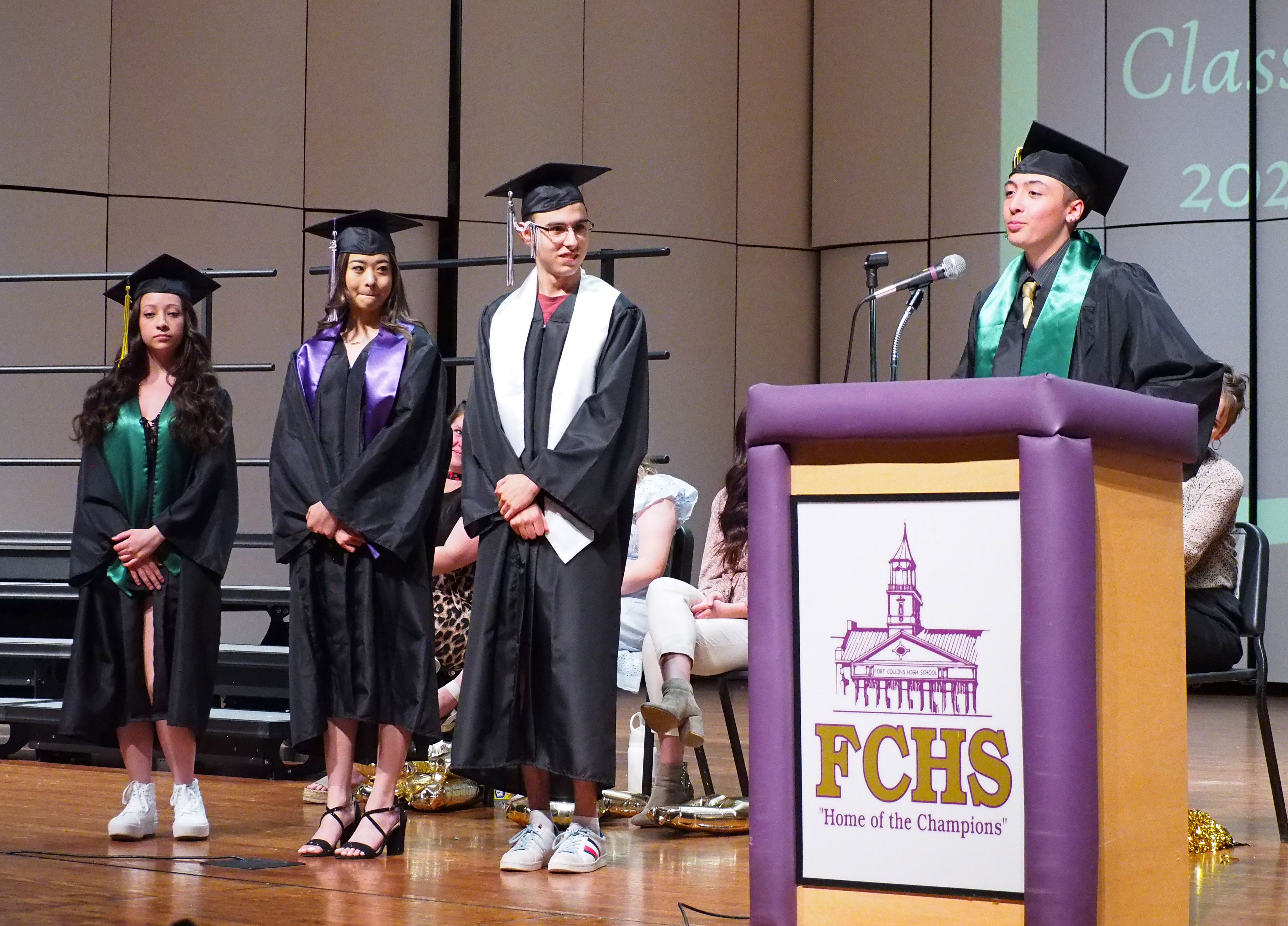 Four graduates on stage at FCHS.