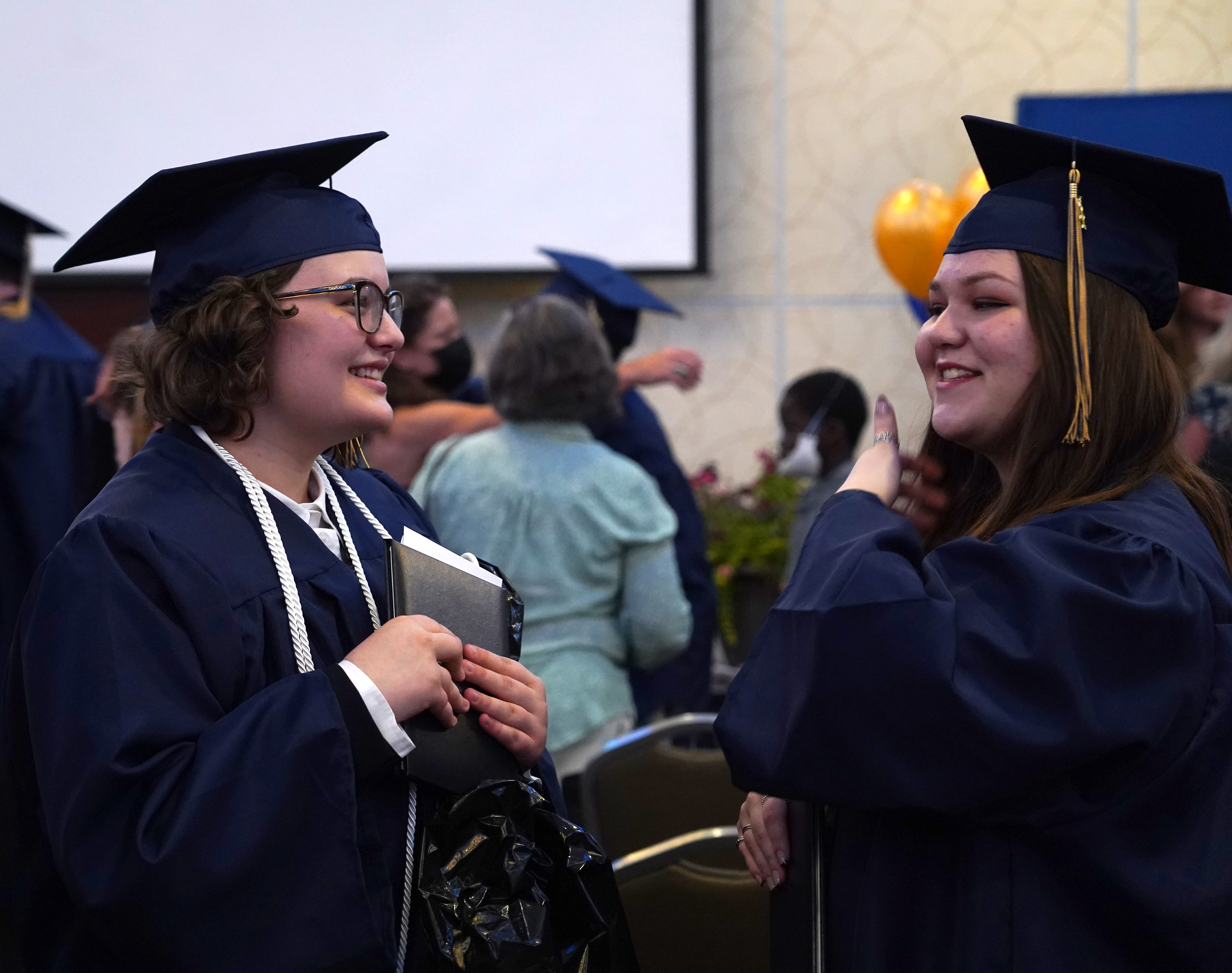 Poudre Global Academy graduates talk with each other. 