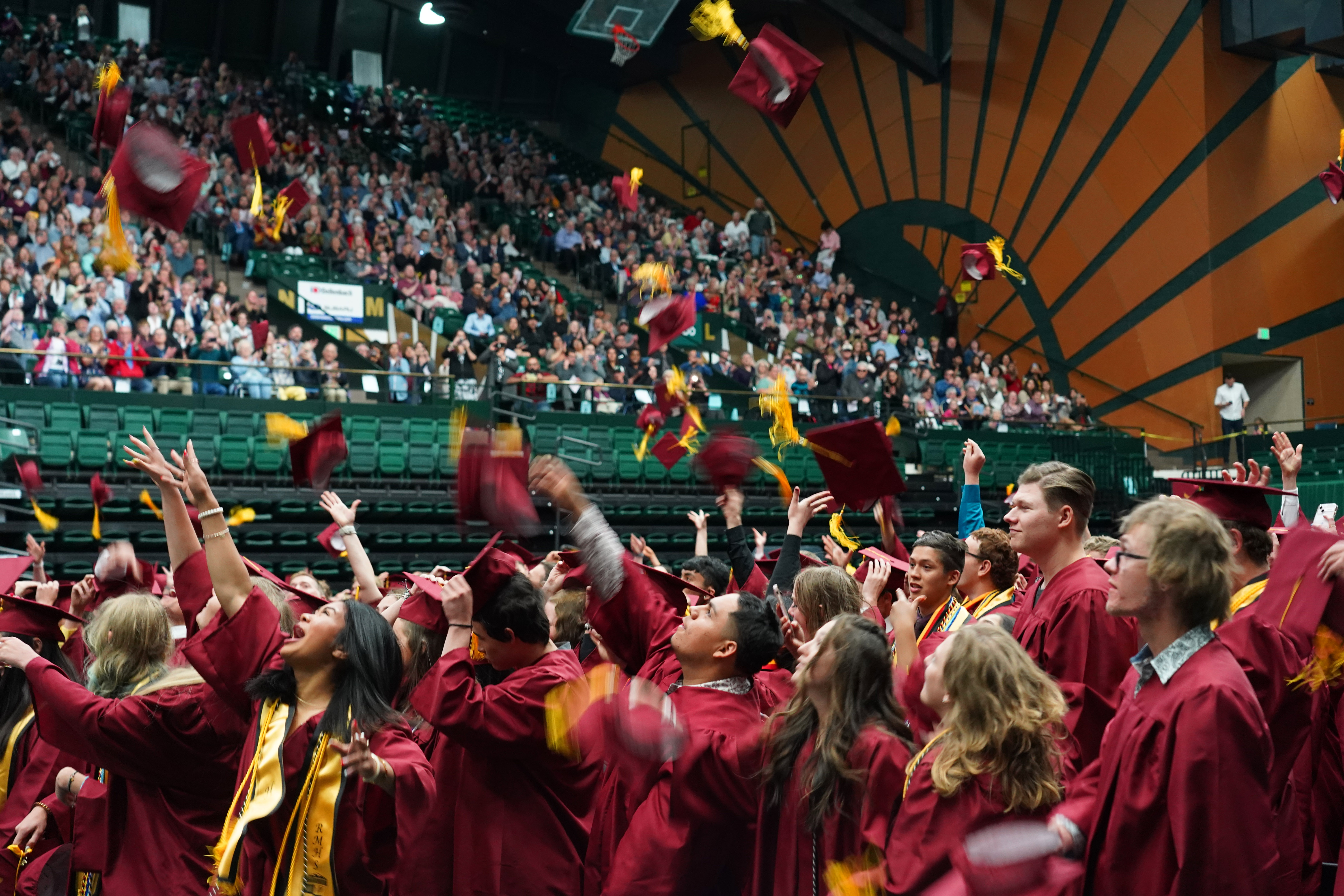 Rocky graduates throw caps in the air at the end of their ceremony. 