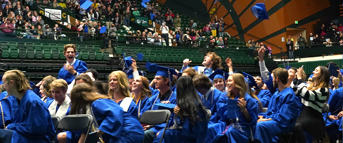 Poudre High School graduates throw caps in the air