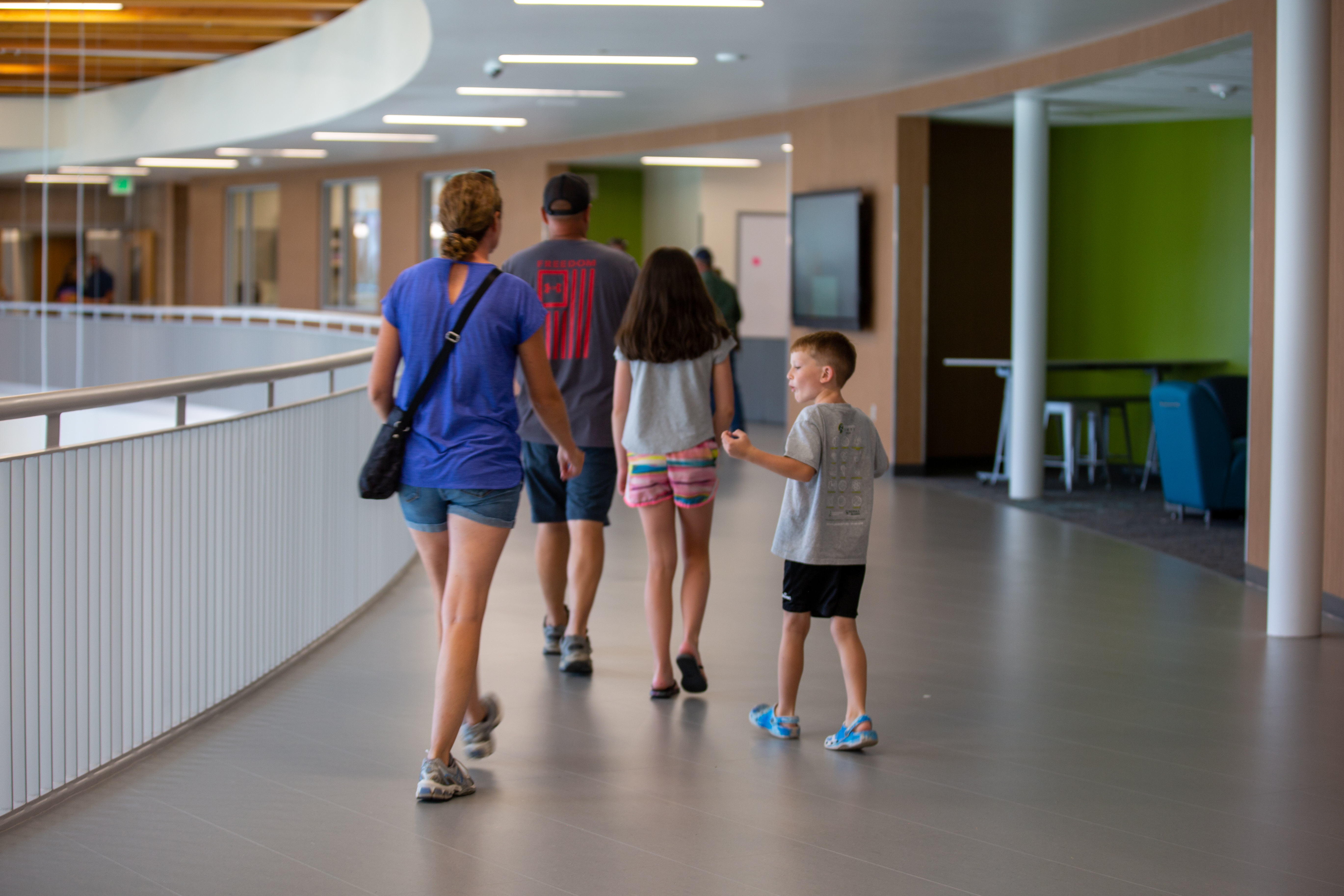 A family tours the new school building. 