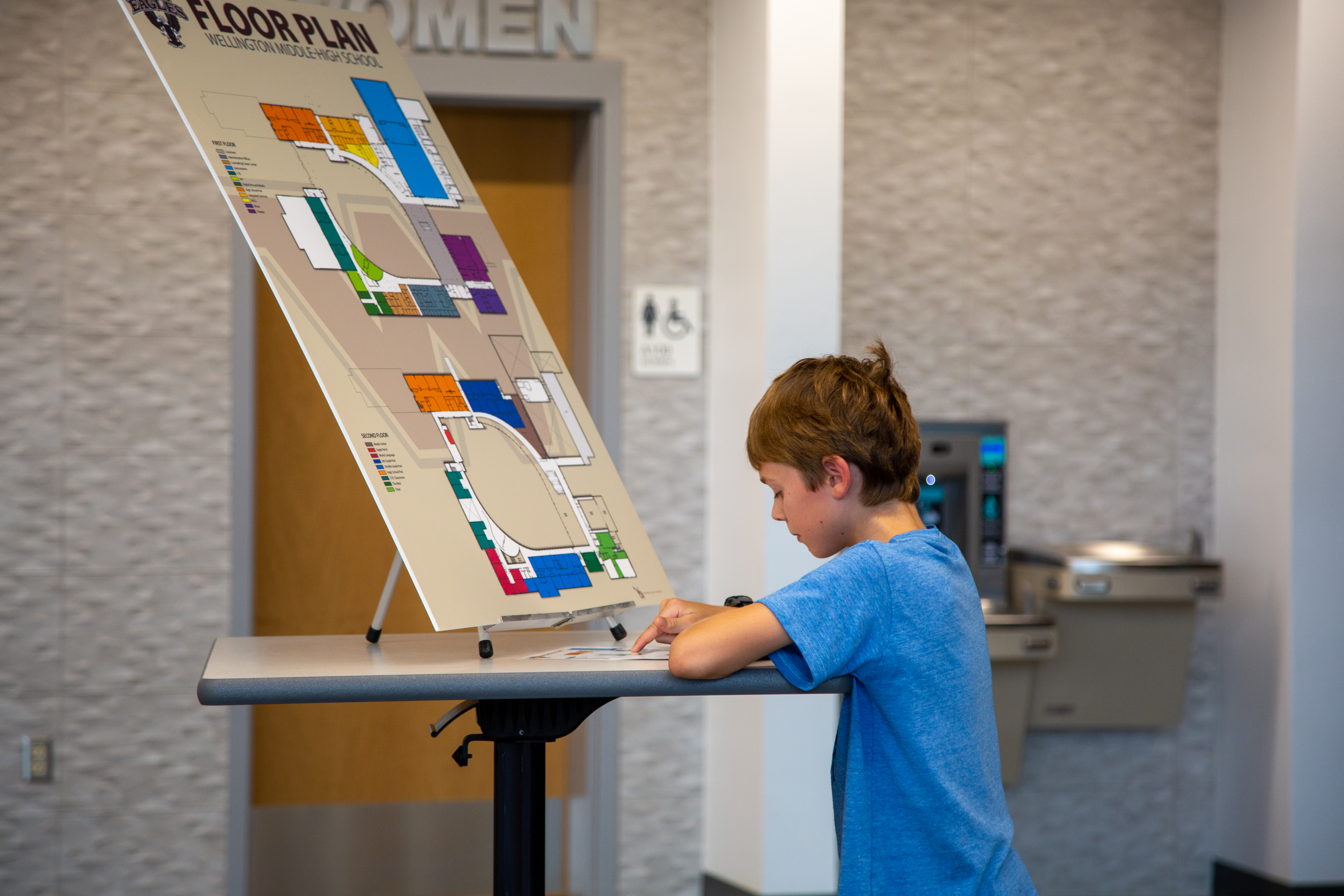 A middle school student looks at information at the celebration. 