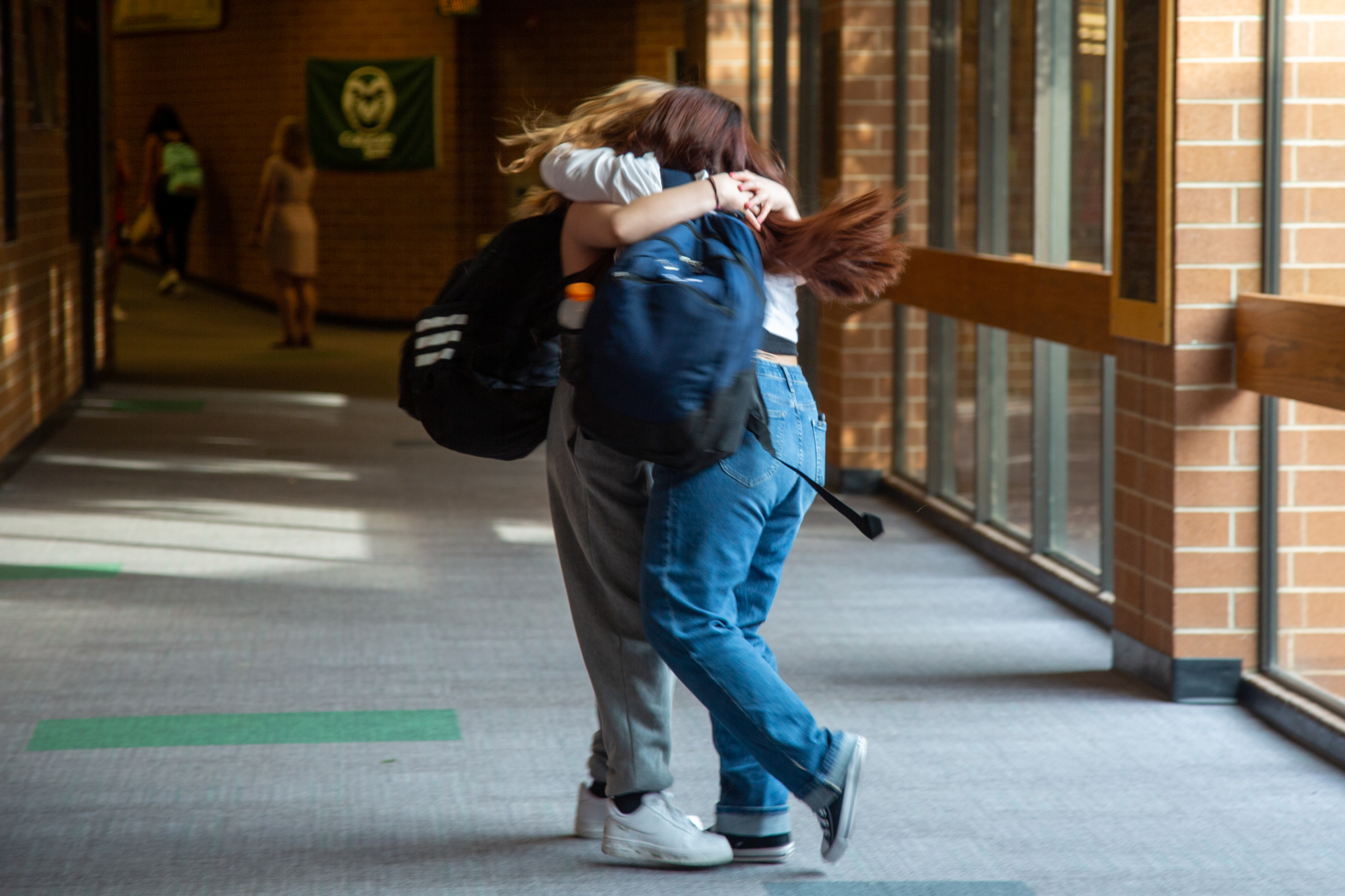 Two Lincoln Middle School students hug.