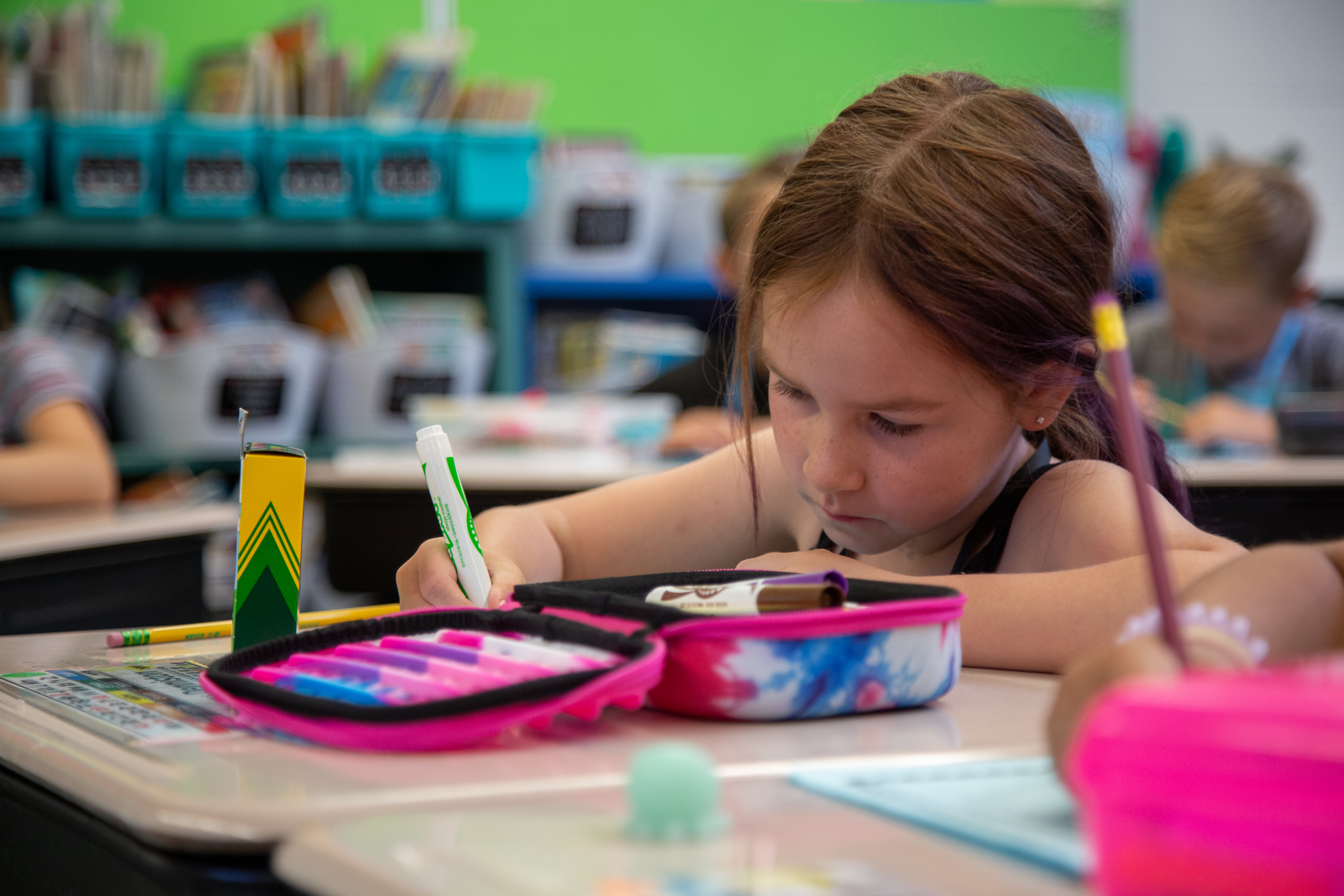 A Tavelli Elementary student works at her desk. 
