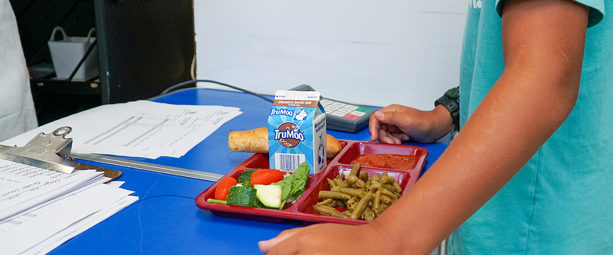 A school meal with papers by it.