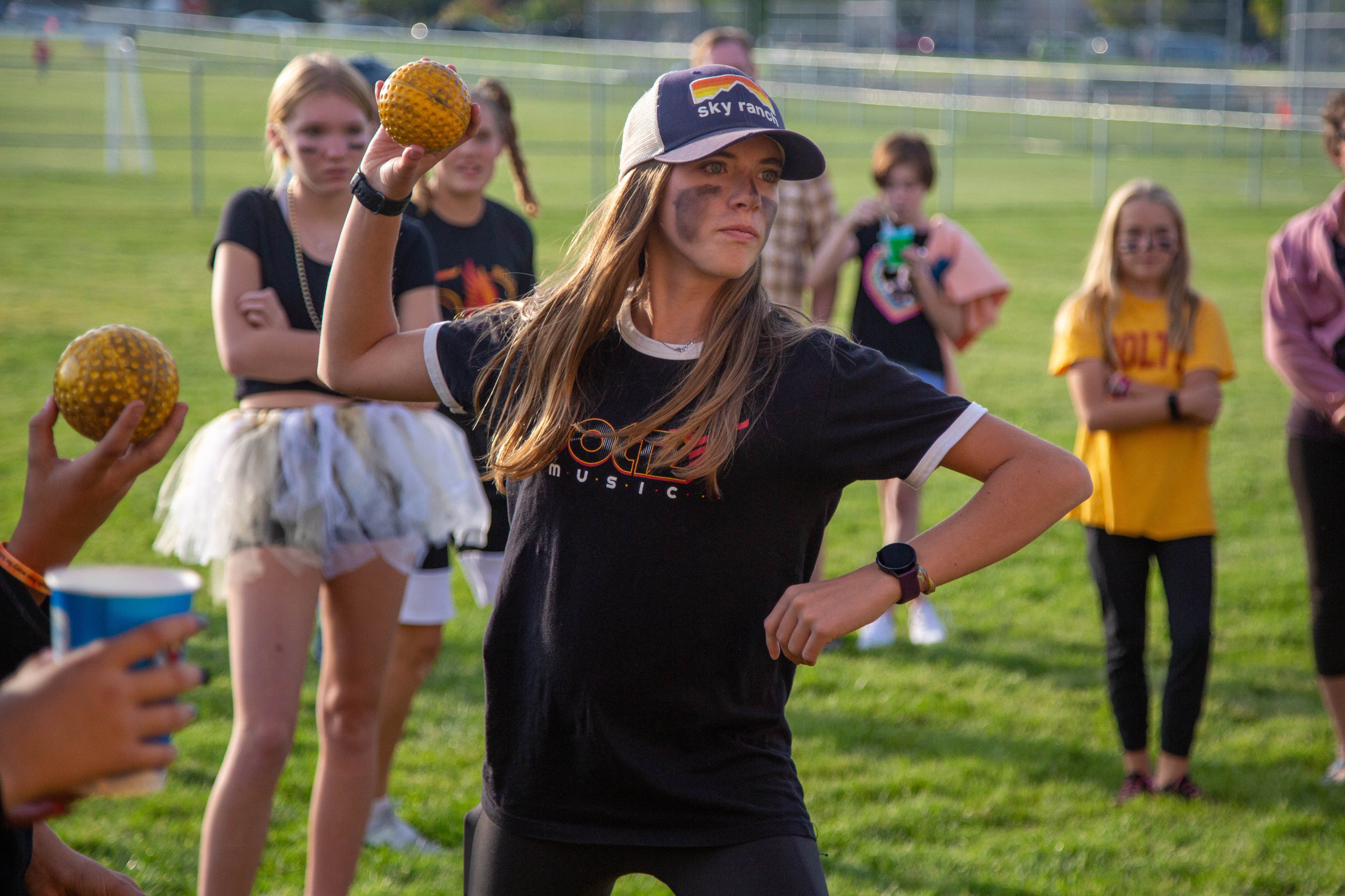 A Boltz female student pitches a ball. 