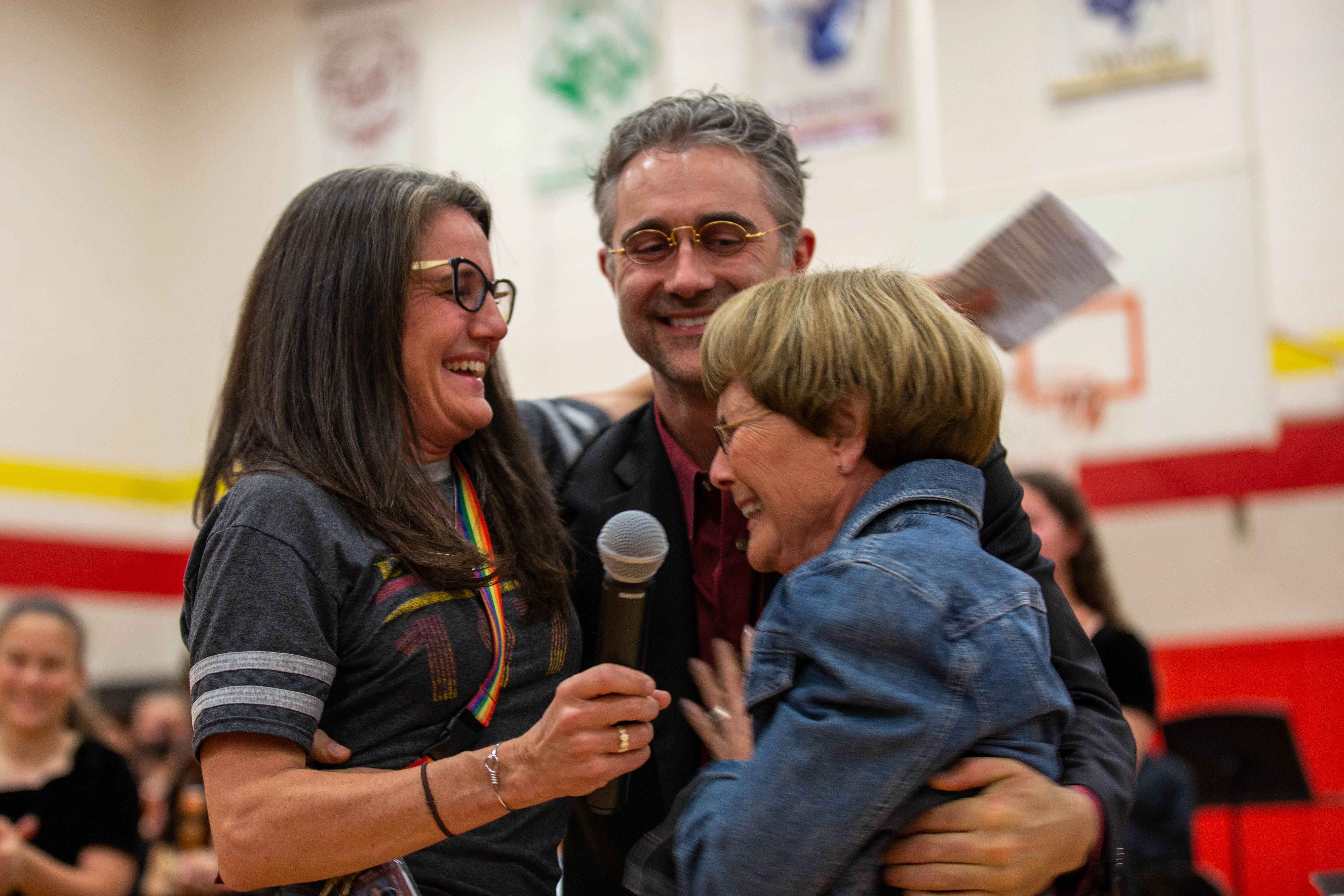 Three people laugh together at the Boltz celebration. 