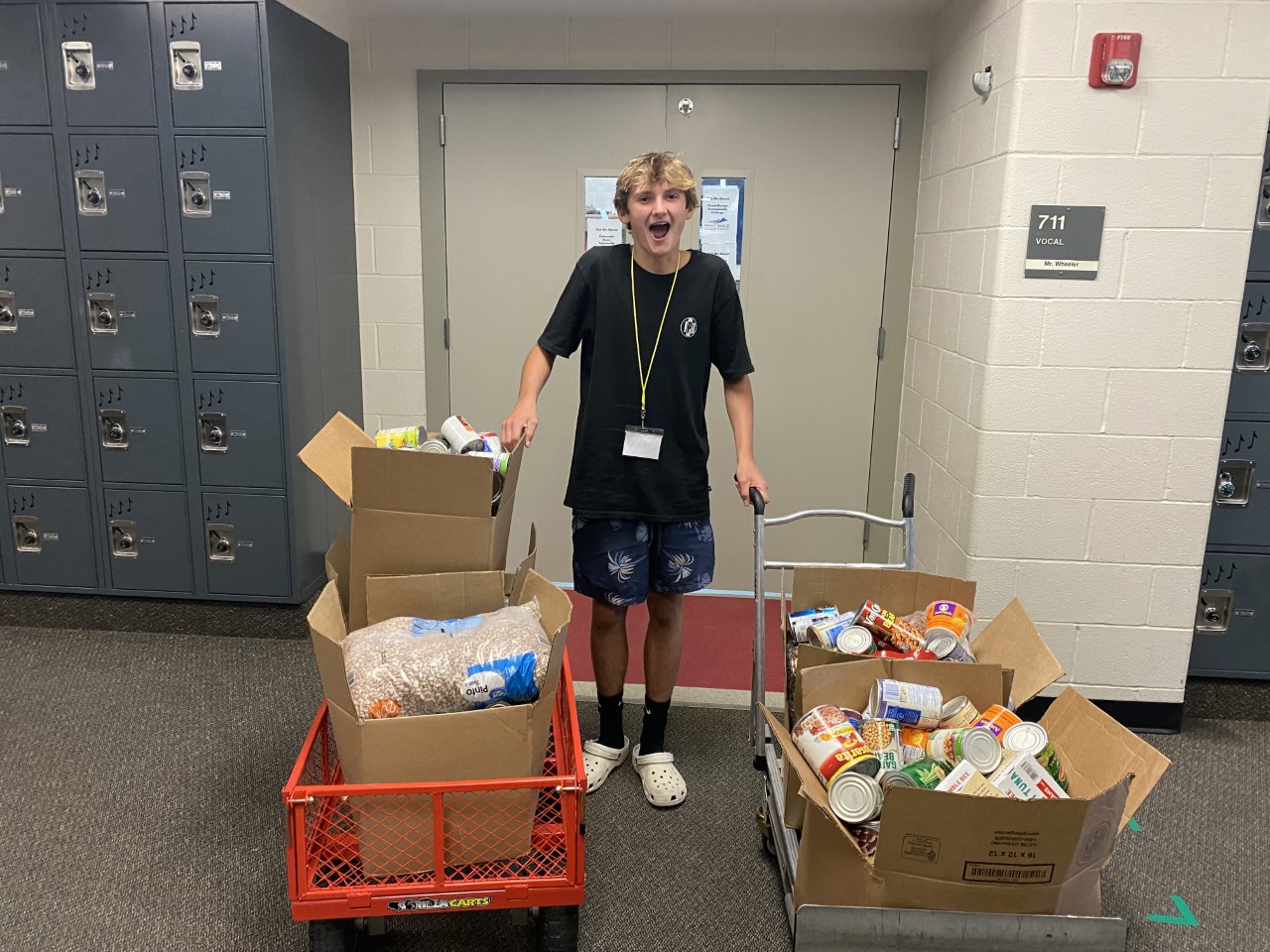 A Kinard Middle School student with boxes of food to donate. 