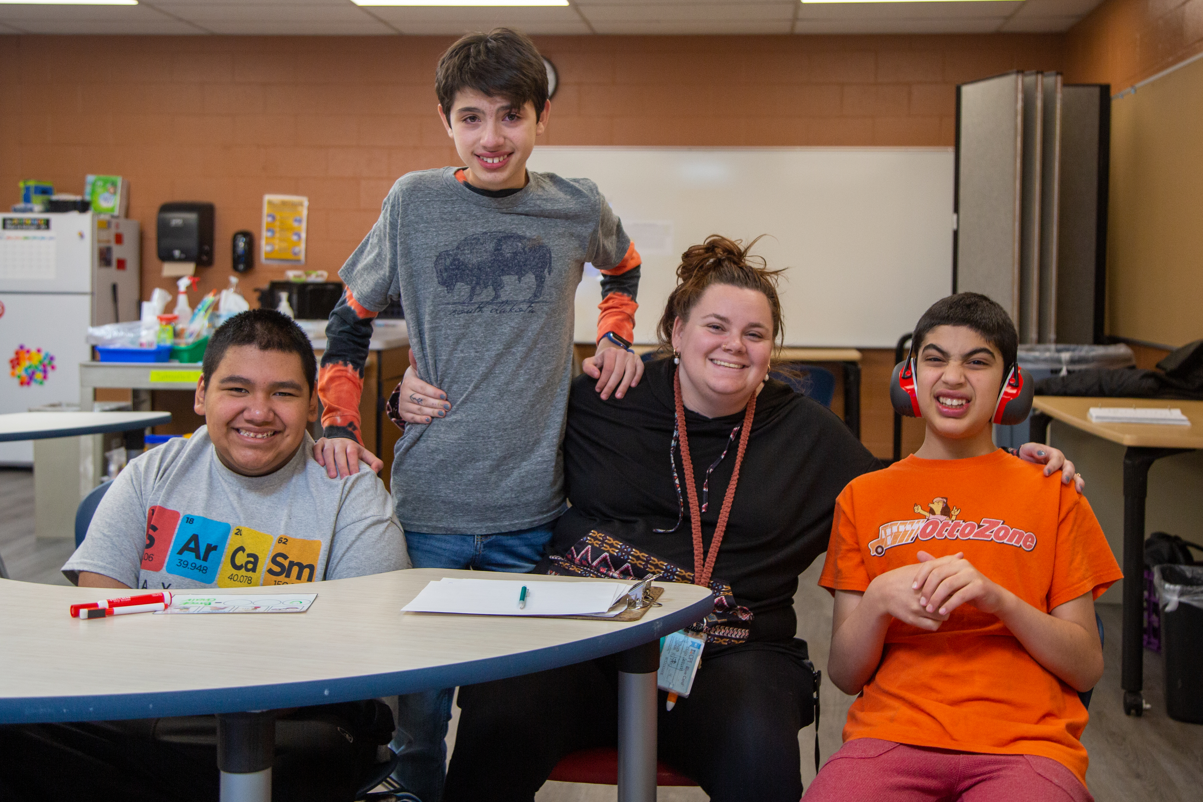 A classified staff member with students at Boltz Middle School. 
