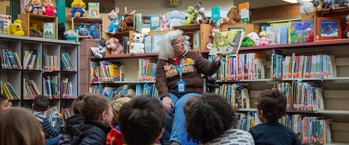 A staff member reads to students at Laurel Elementary School. 