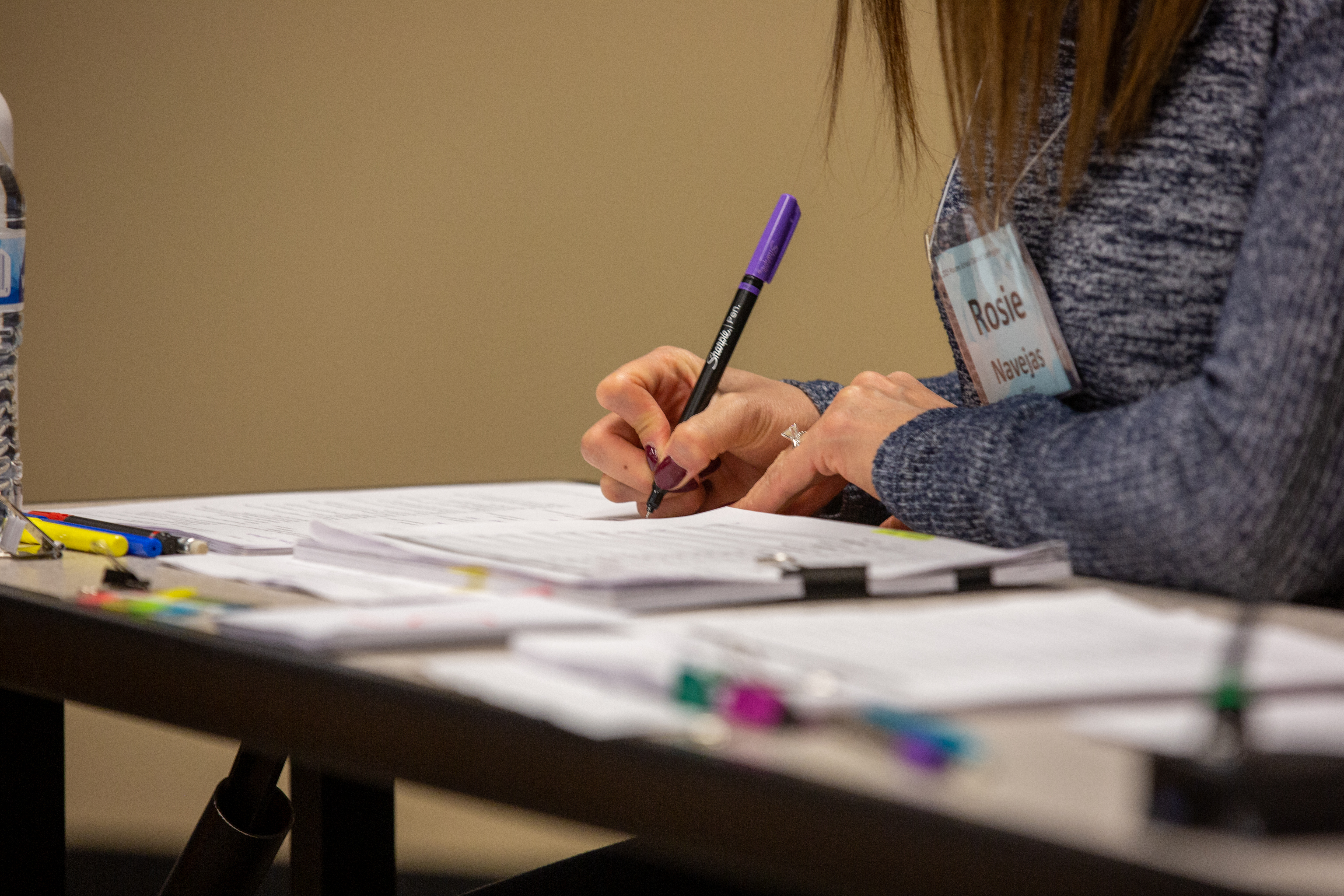 A spelling bee judge makes notes. 