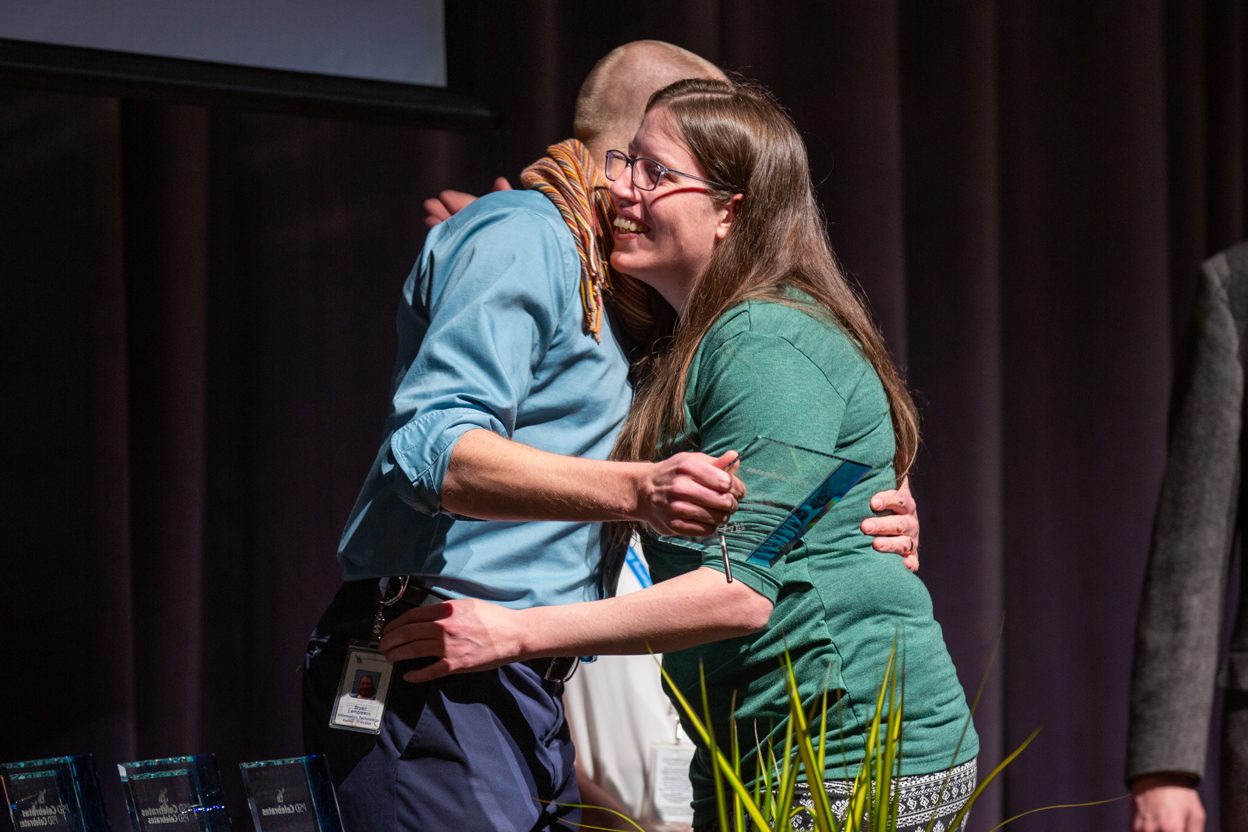 A PSD staff award winner gets a hug.