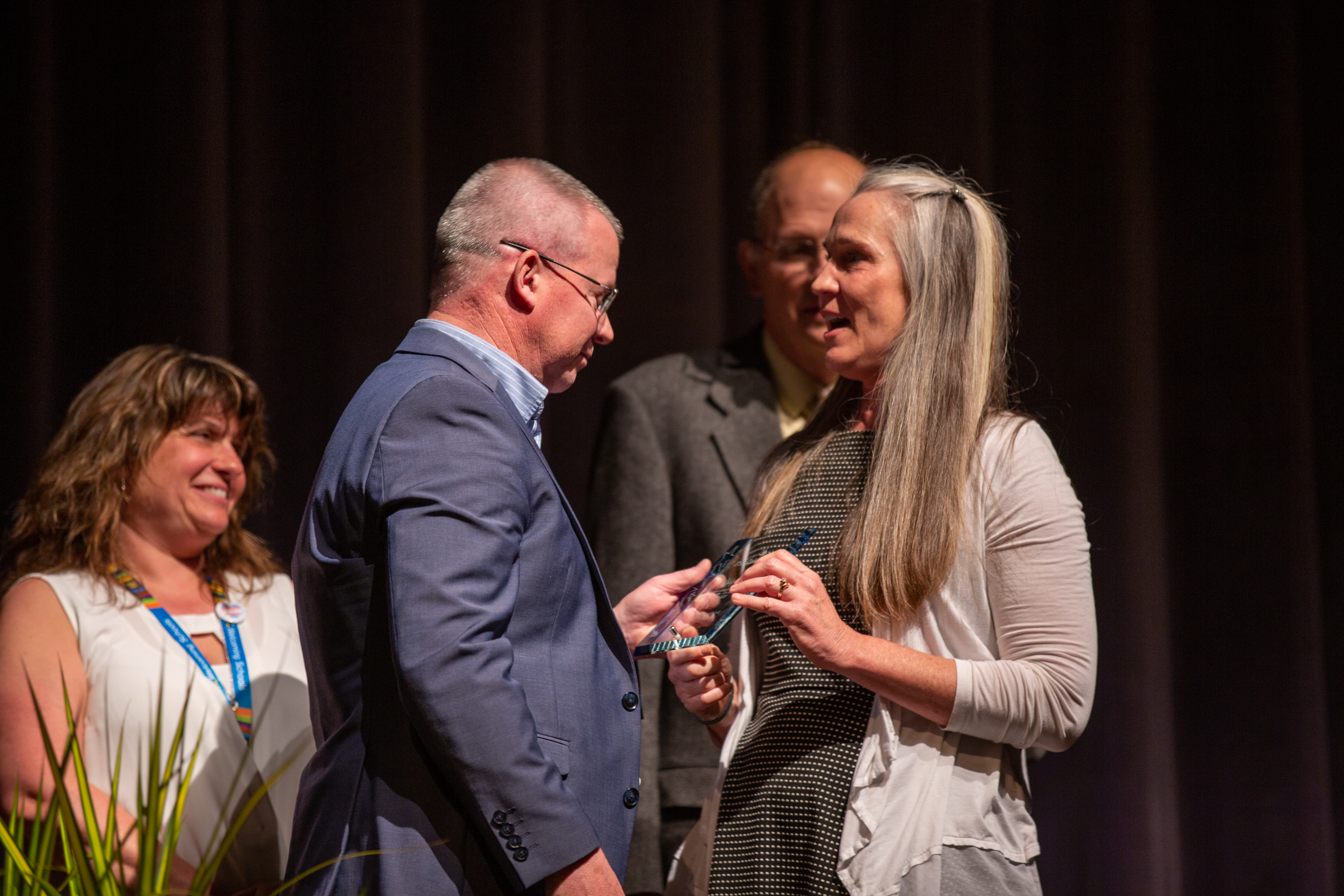 An staff member receives her award.