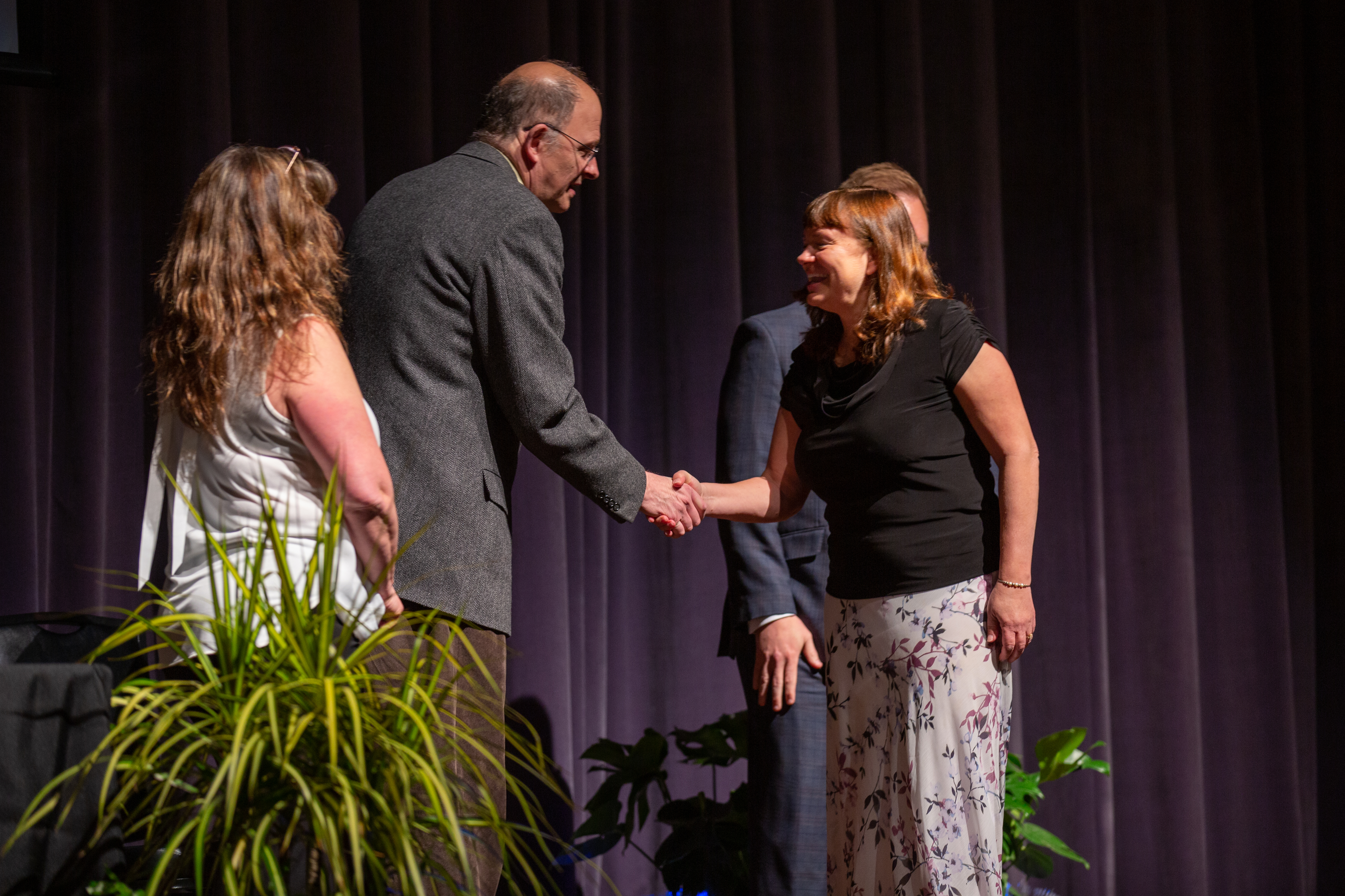 PSD staff member is celebrated at an awards ceremony.