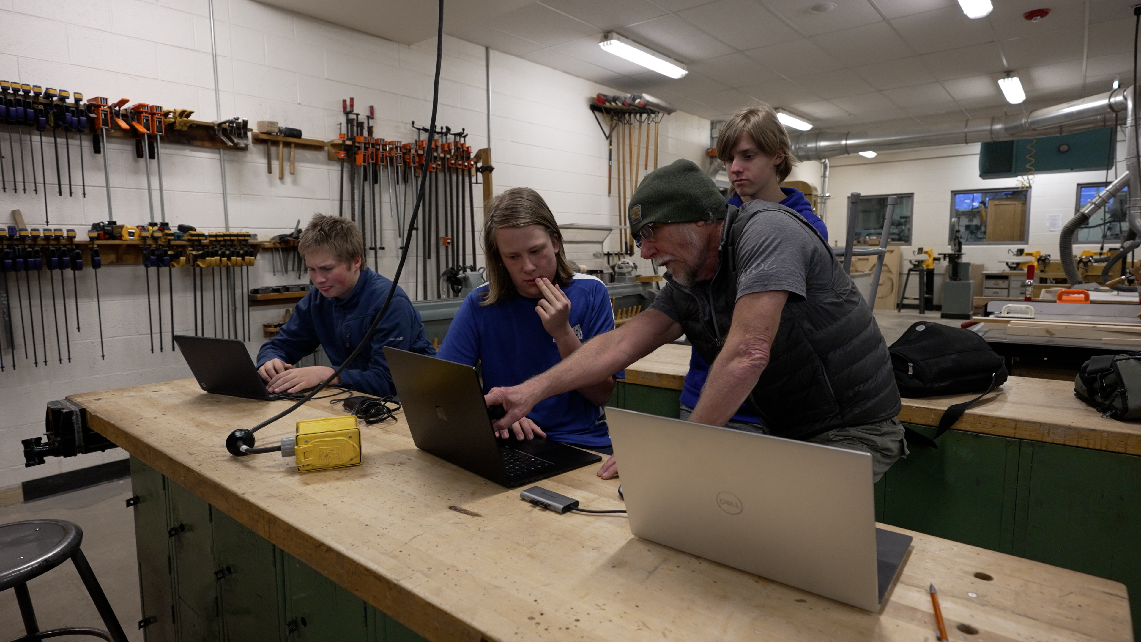 A volunteer helps out with robotics class at Poudre High School. 