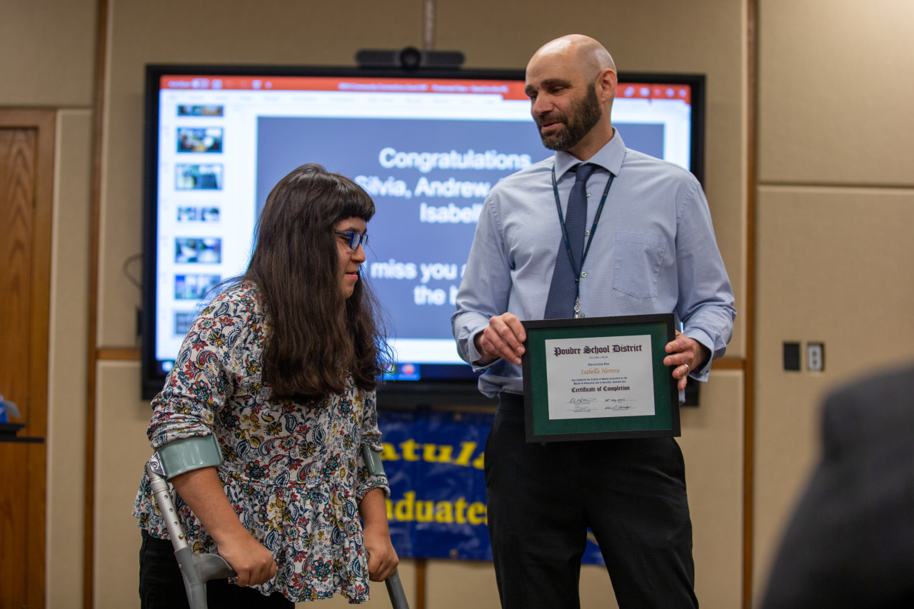 A Community Connections graduate receives her certificate. 