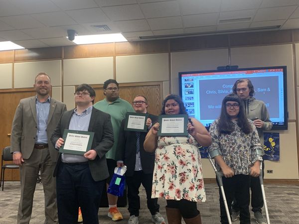 Community Connections grads pose for a photo with the superintendent. 