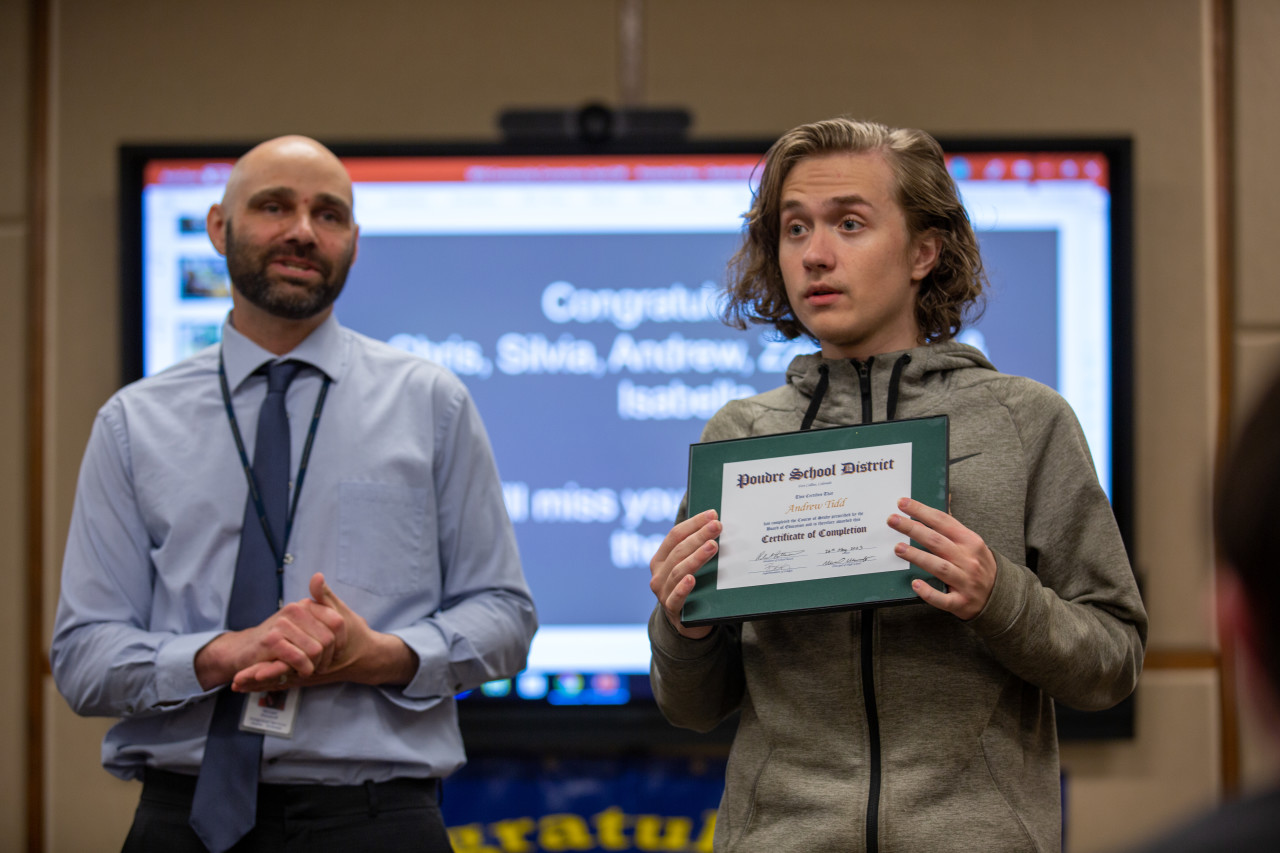 A Community Connections graduate holds his certificate. 