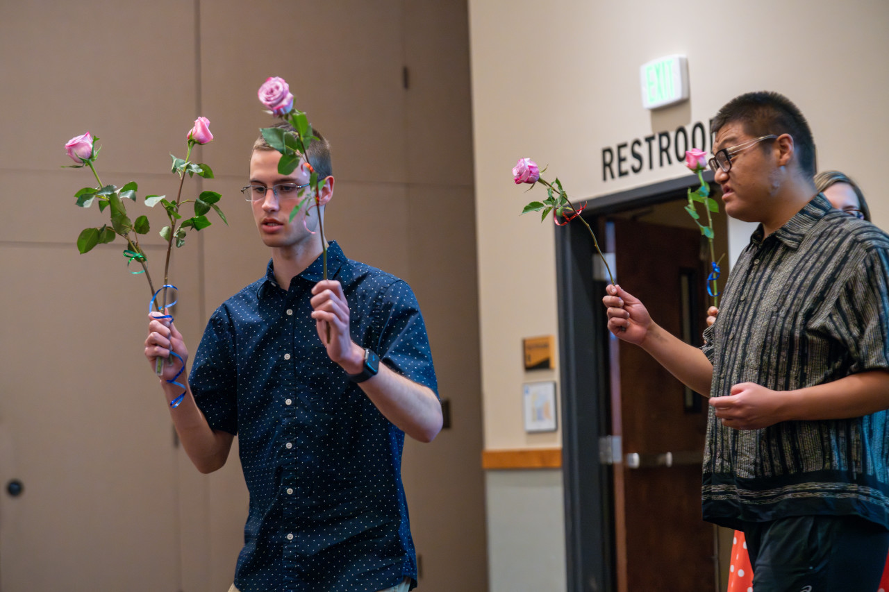 Two Project SEARCH graduates holding roses. 