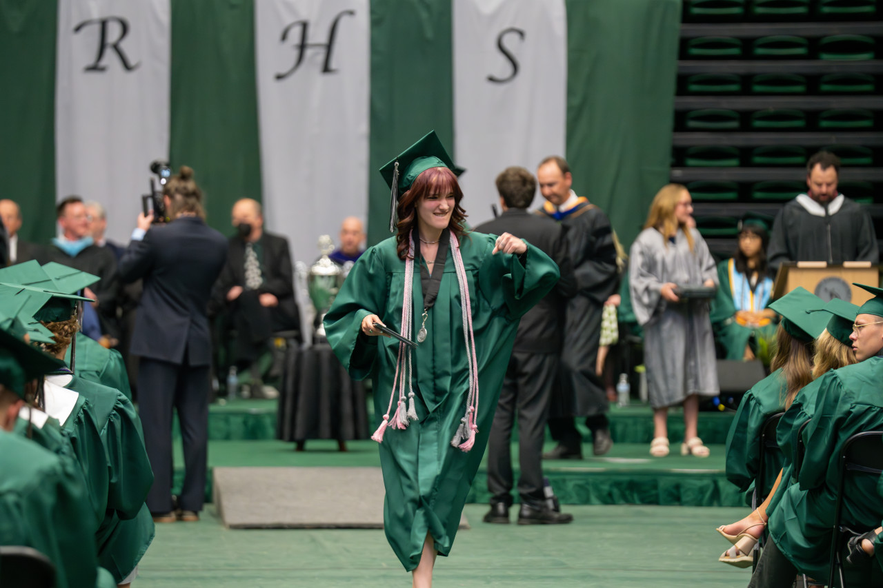 A Fossil Ridge High School grad walks back with her diploma in hand. 