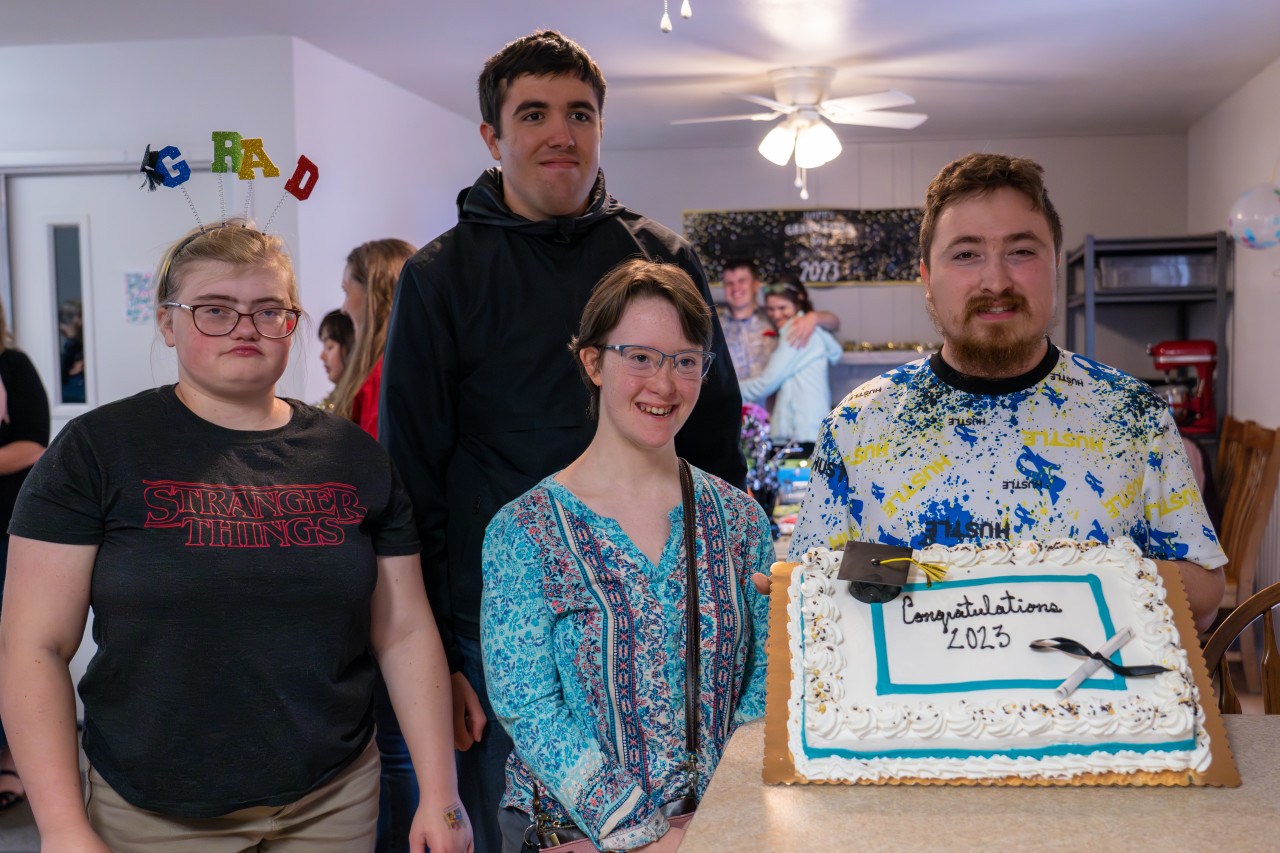 Cooper Home graduates with a cake.