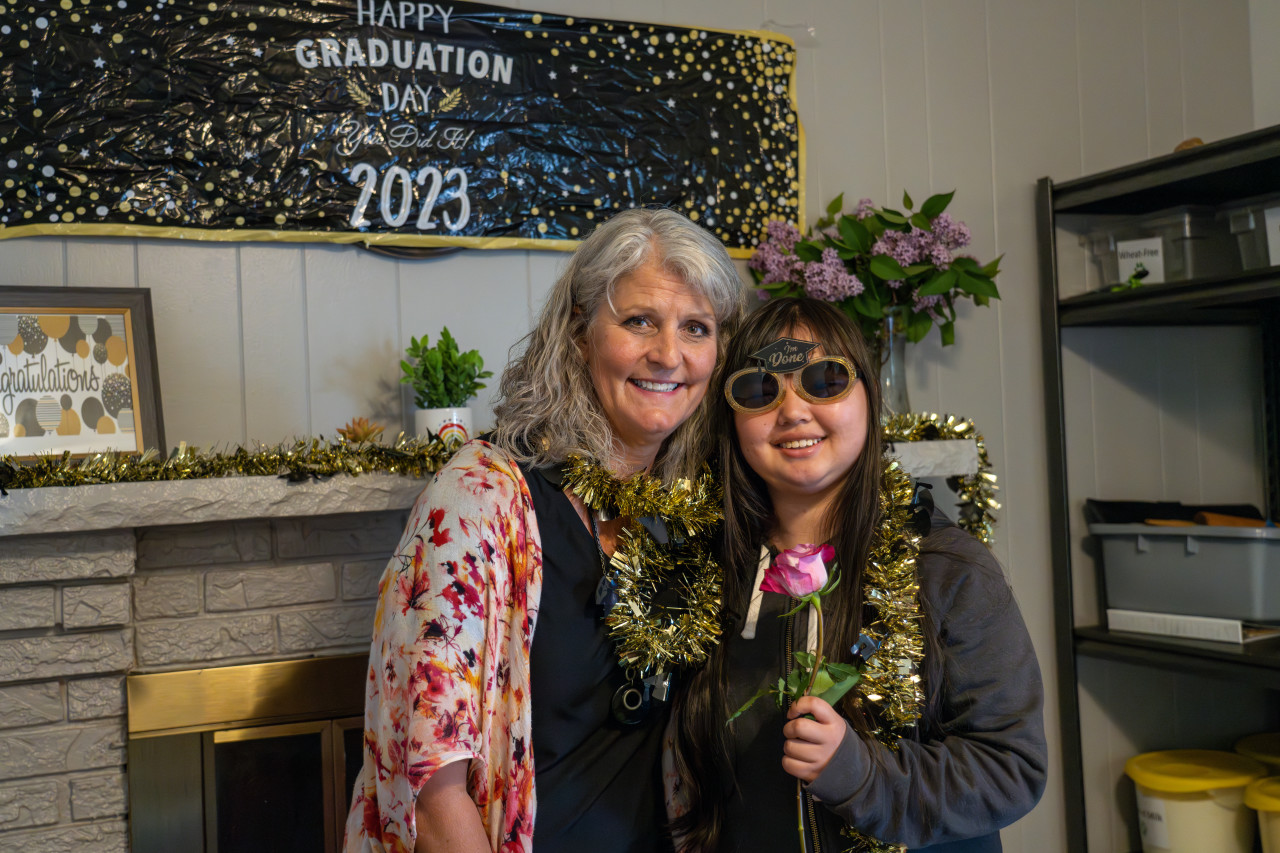 A Cooper Home graduate smiles at the camera. 