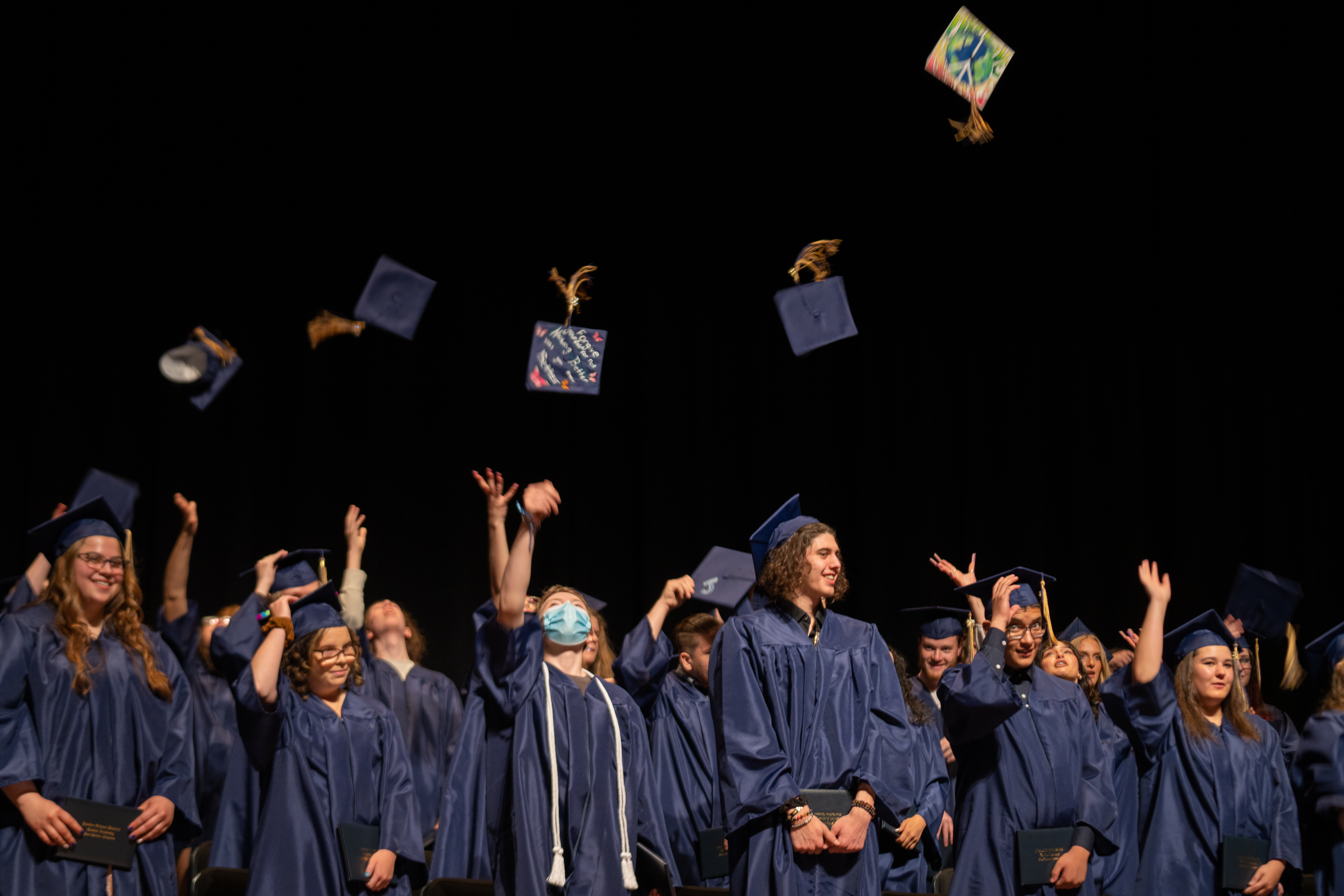Poudre Global Academy grads throw caps in the air. 