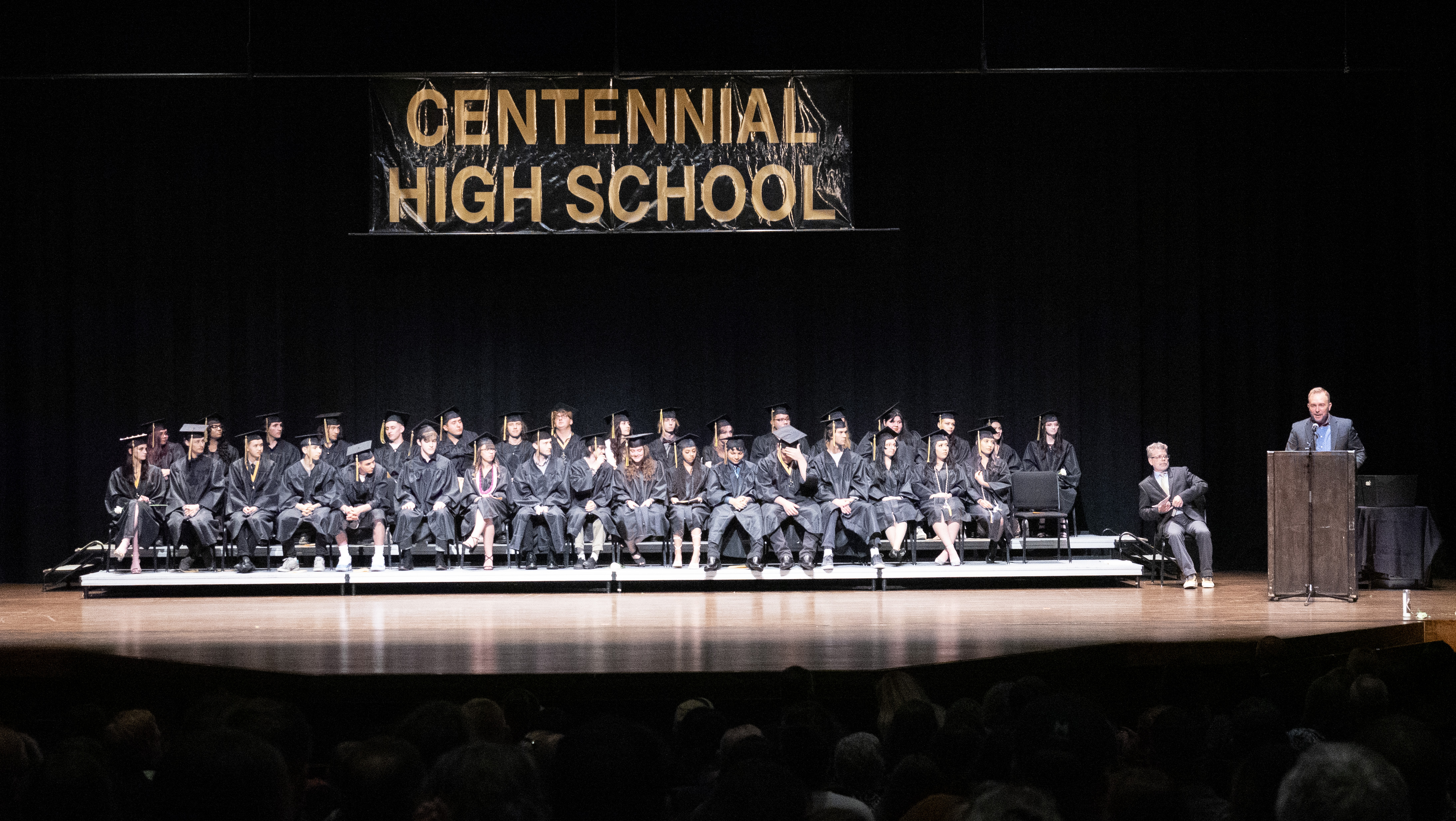 Centennial High School graduates sitting together. 