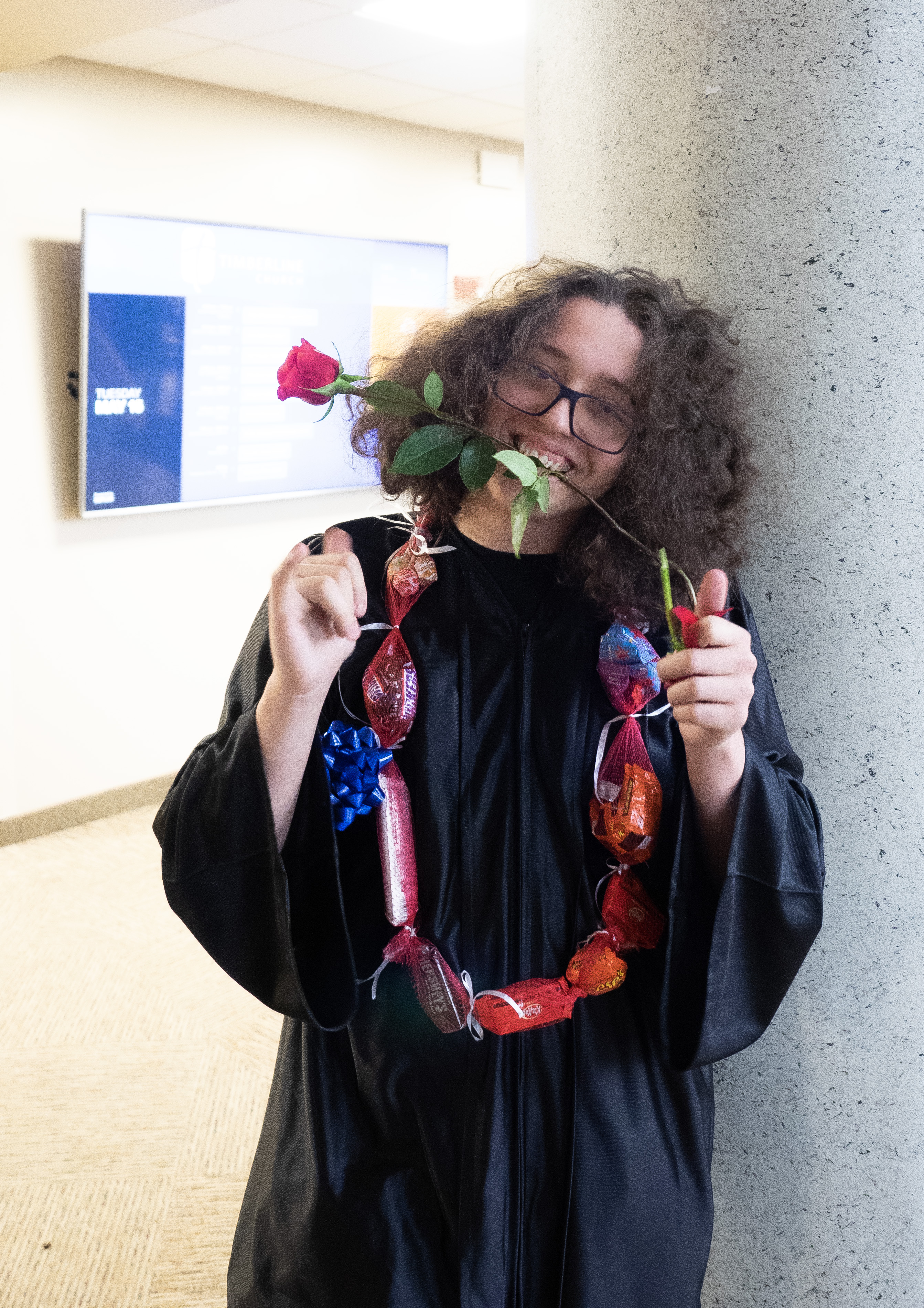 An OU graduate smiles at the camera. 