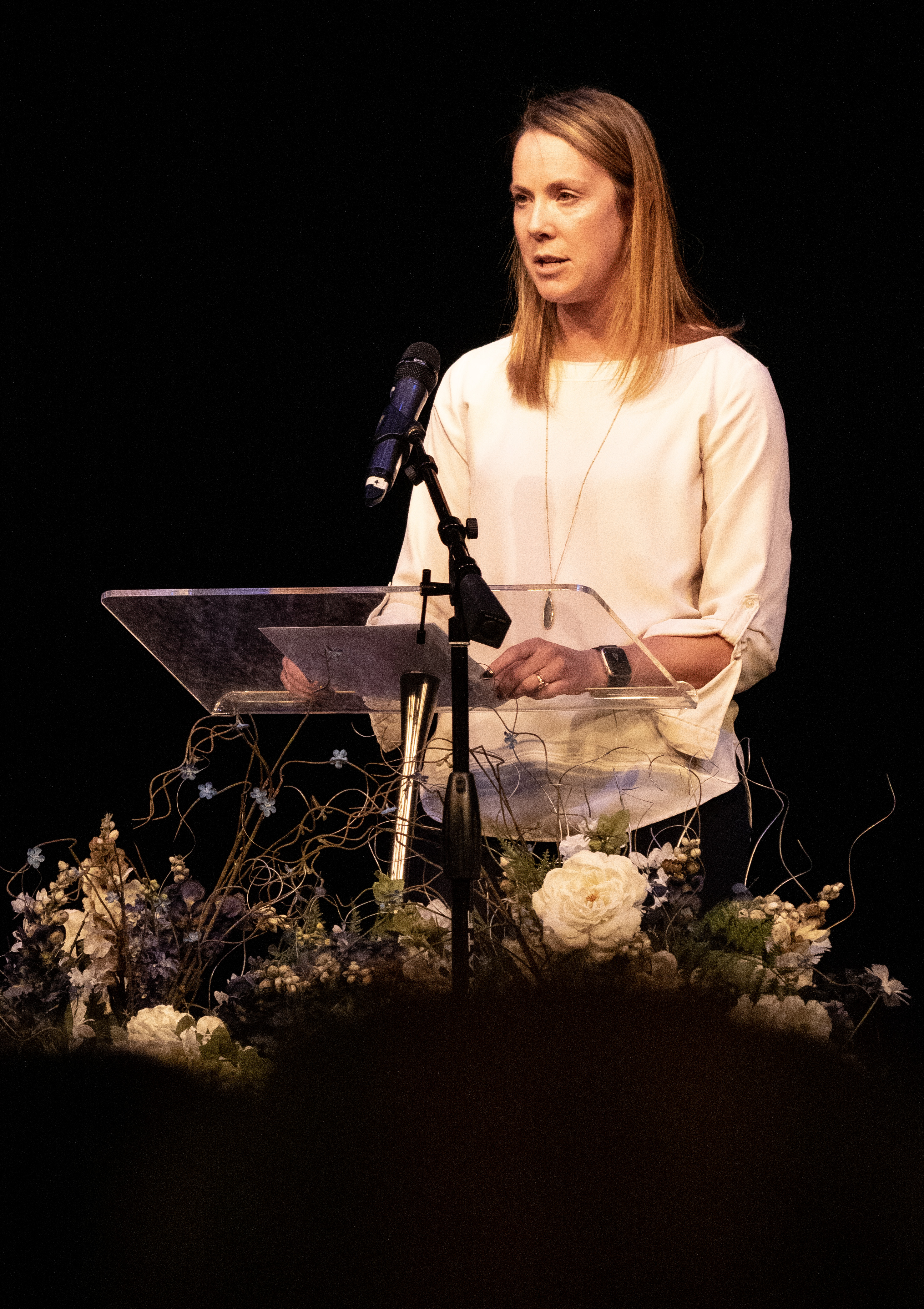 Someone speaks at the podium on stage at the OU ceremony. 