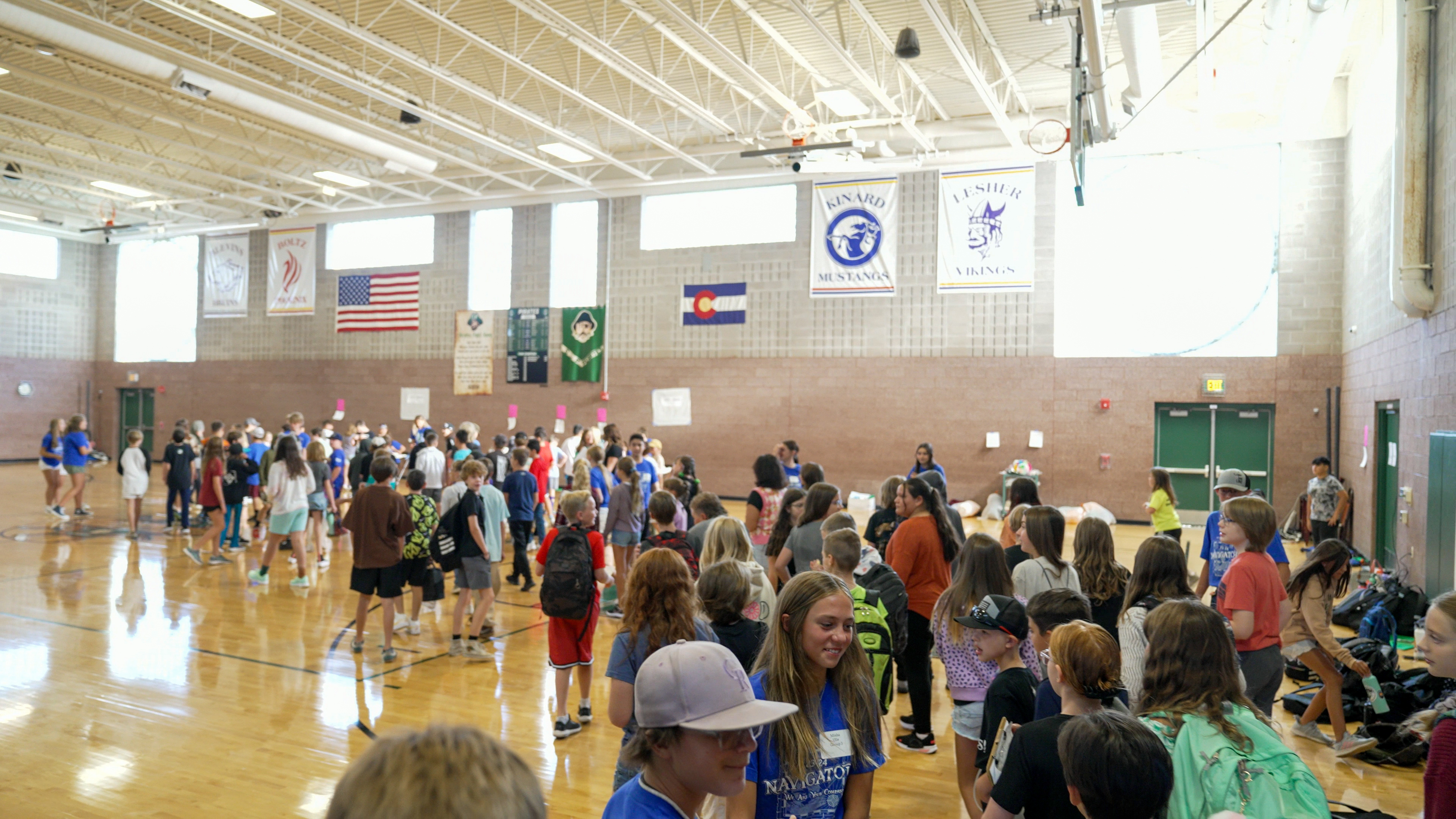 A crowd of students in a middle school gym. 