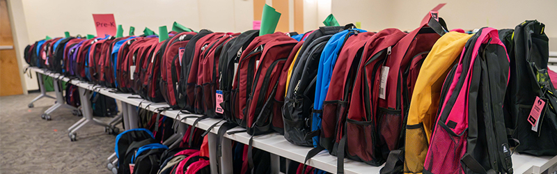 Backpacks lined up in a row. 
