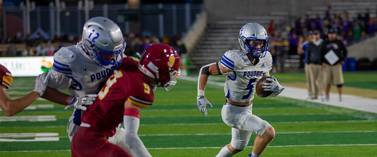 A Poudre High football player carries the ball at the Canvas Community Classic game. 
