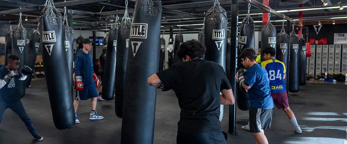 Boxing Club middle school participants practice their skills with punching bags.