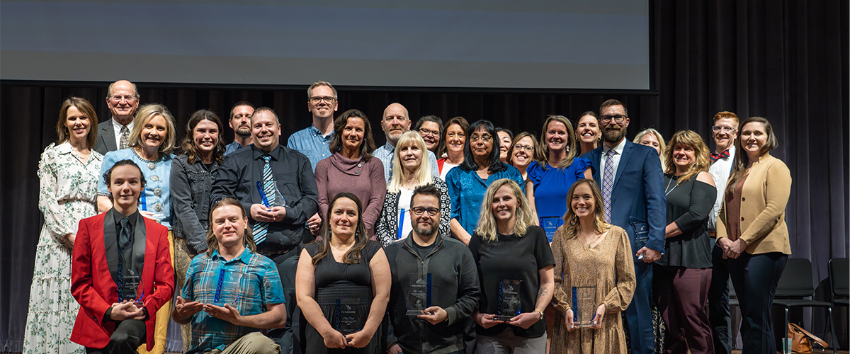 All outstanding staff award winners pose together. 