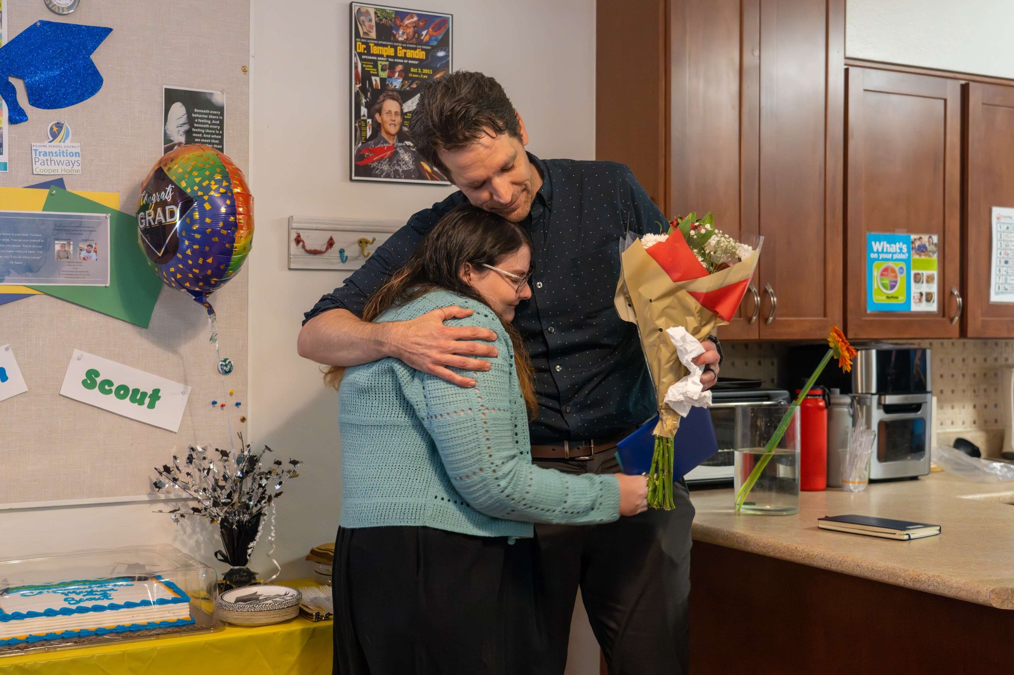 A Cooper Home graduate hugs the director.