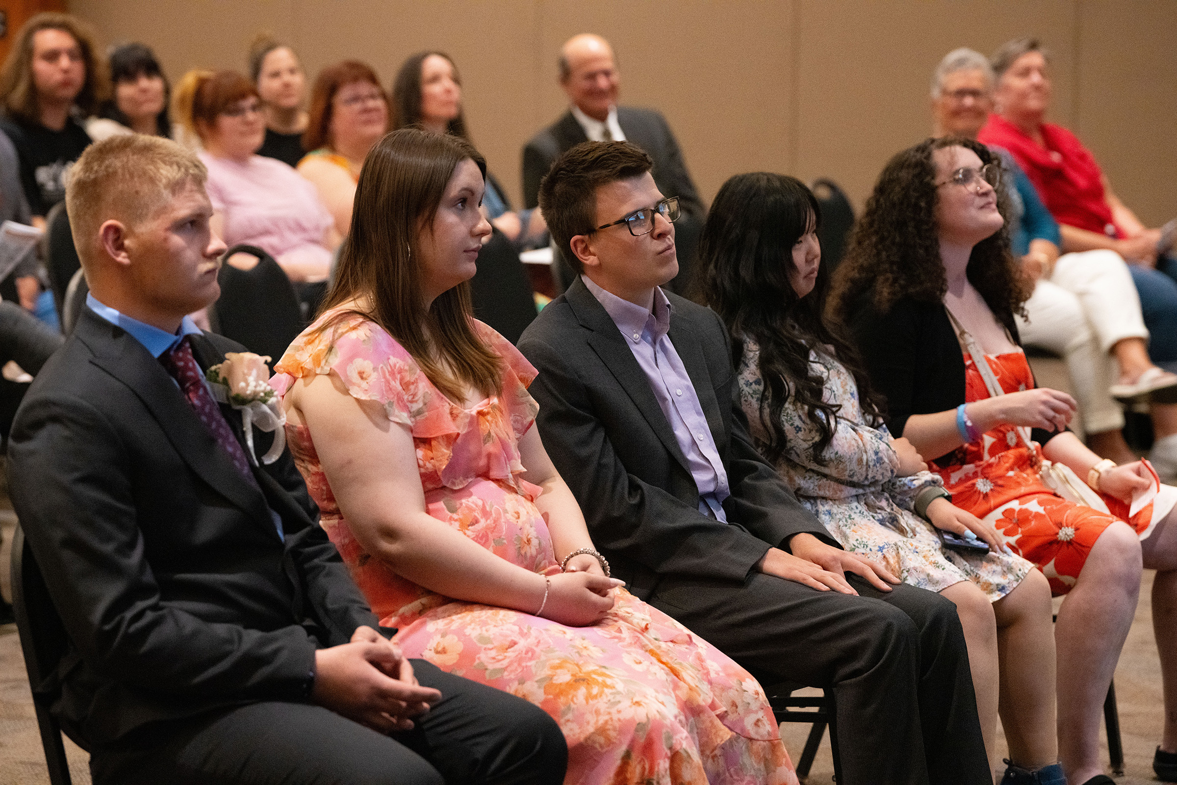 Project SEARCH graduates listen at their celebration.