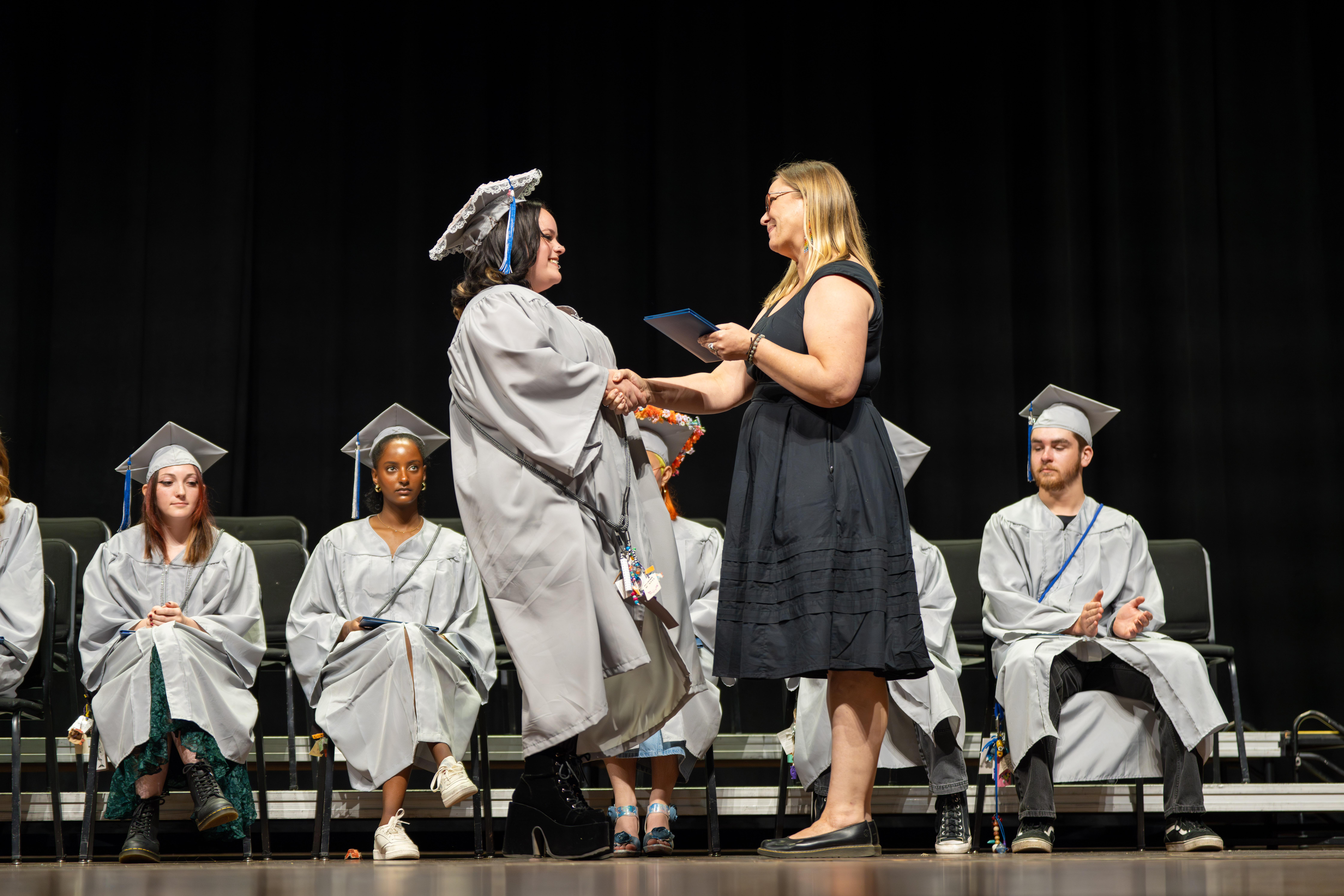 Polaris Expeditionary Learning School grad shakes hand with the principal. 
