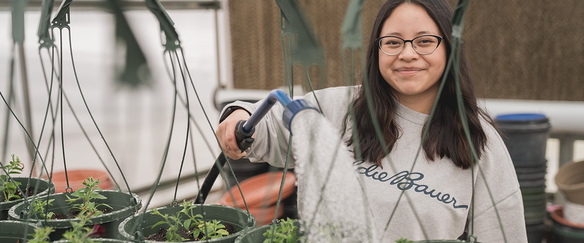 A PHS student watering plants.