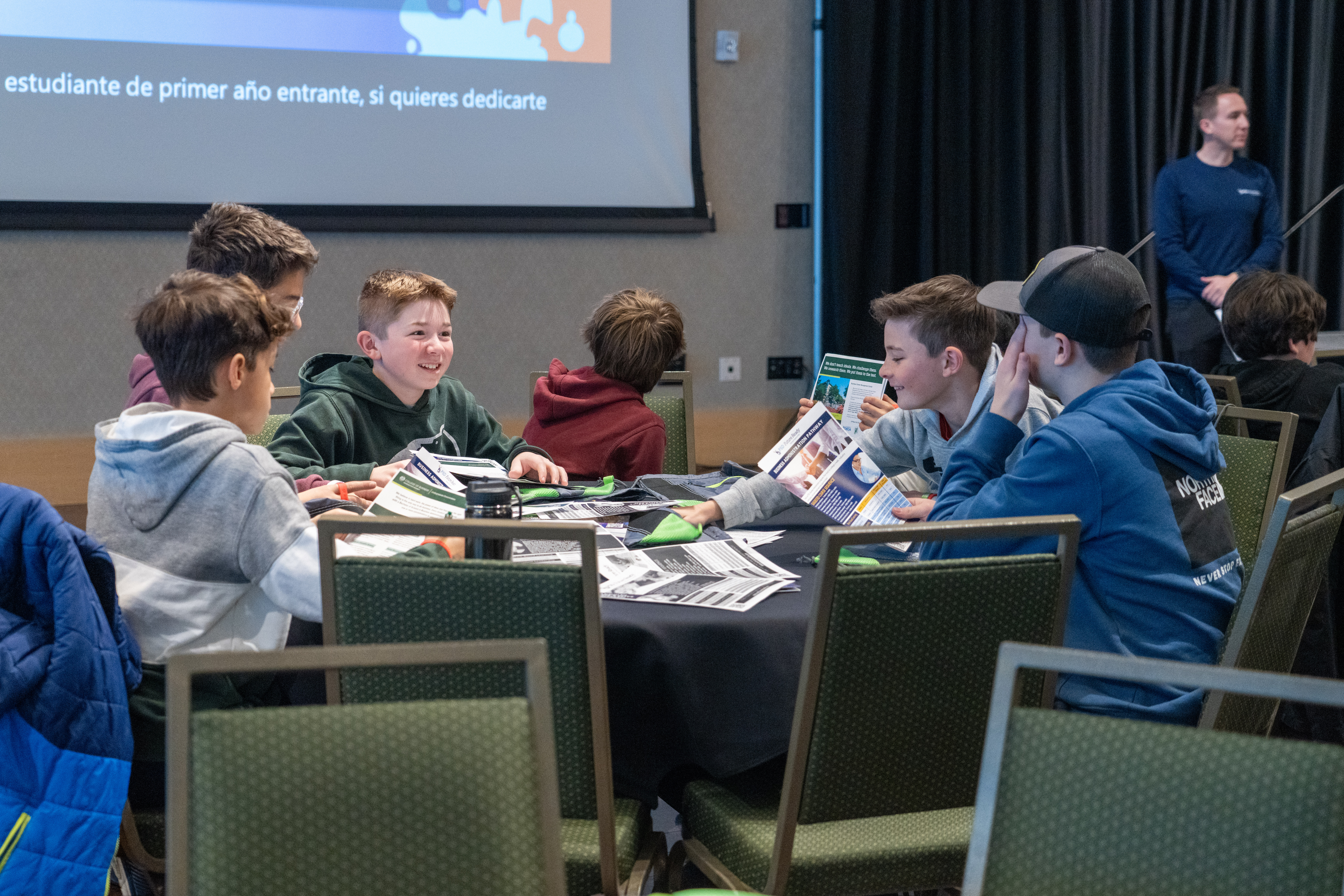 Middle school students talk at a table during a CSU Career Day. 